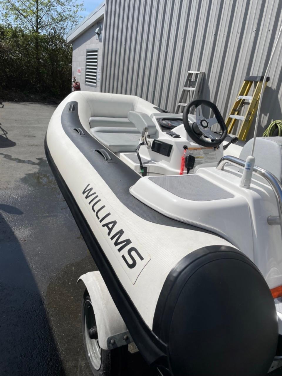 2022 Williams Jet Tenders TurboJet 325, white inflatable boat, parked outdoors.