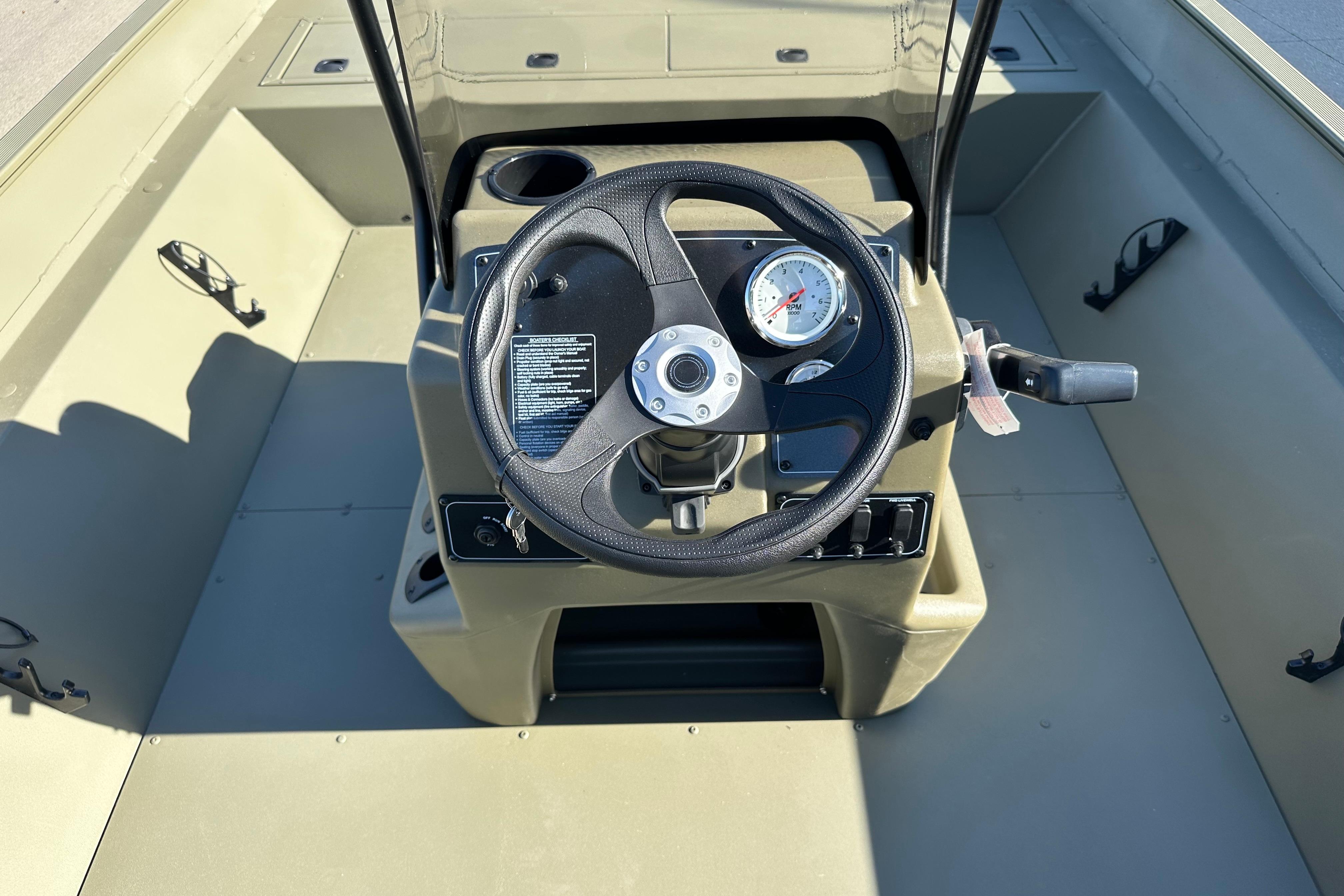 2026 Tracker Grizzly 2072 CC boat console with steering wheel and gauges.