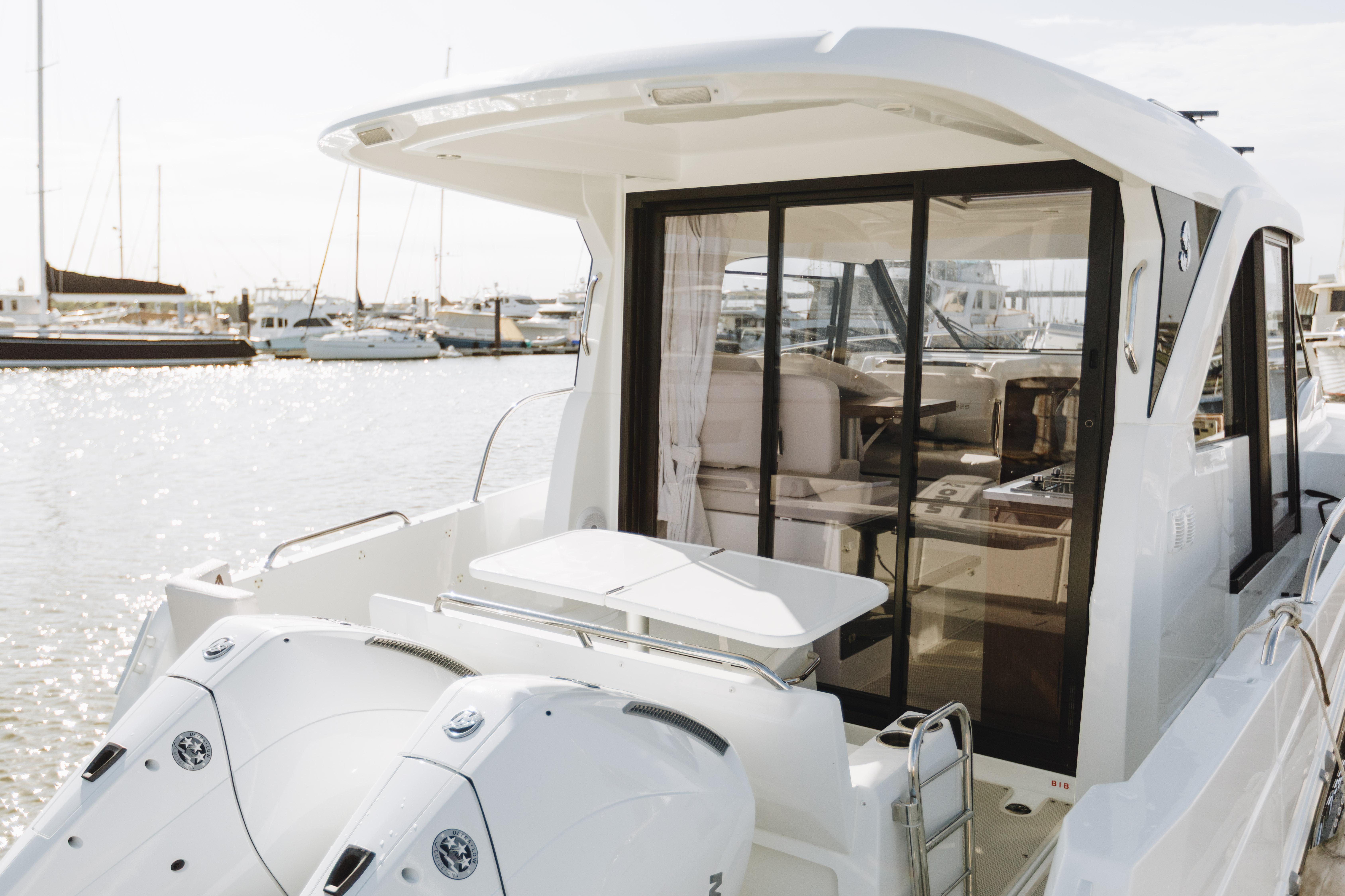 2026 Beneteau Antares 9 boat with dual engines, docked in a marina.
