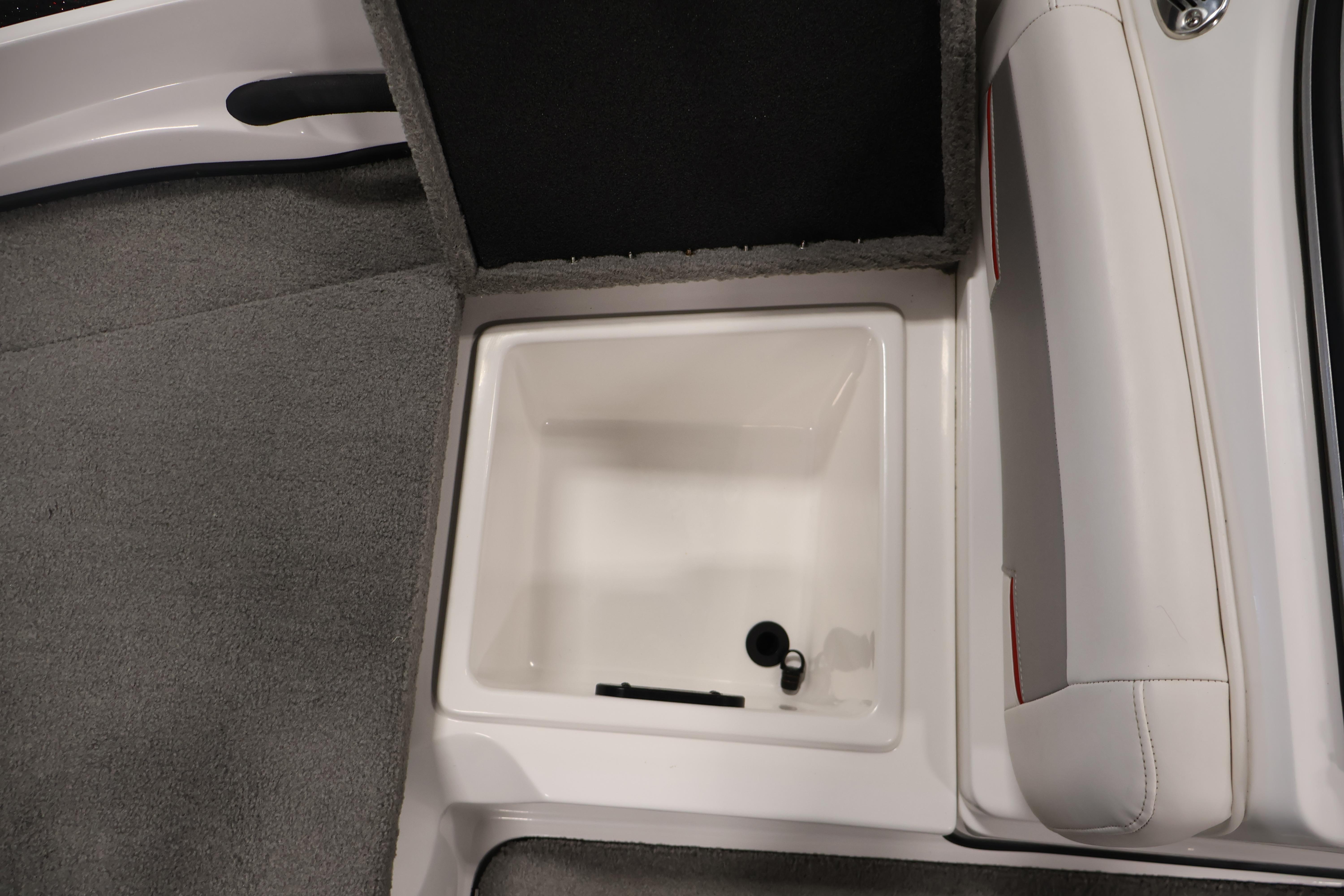 2019 Nitro Z19 Sport boat storage compartment with open lid, featuring gray carpet and white interior.