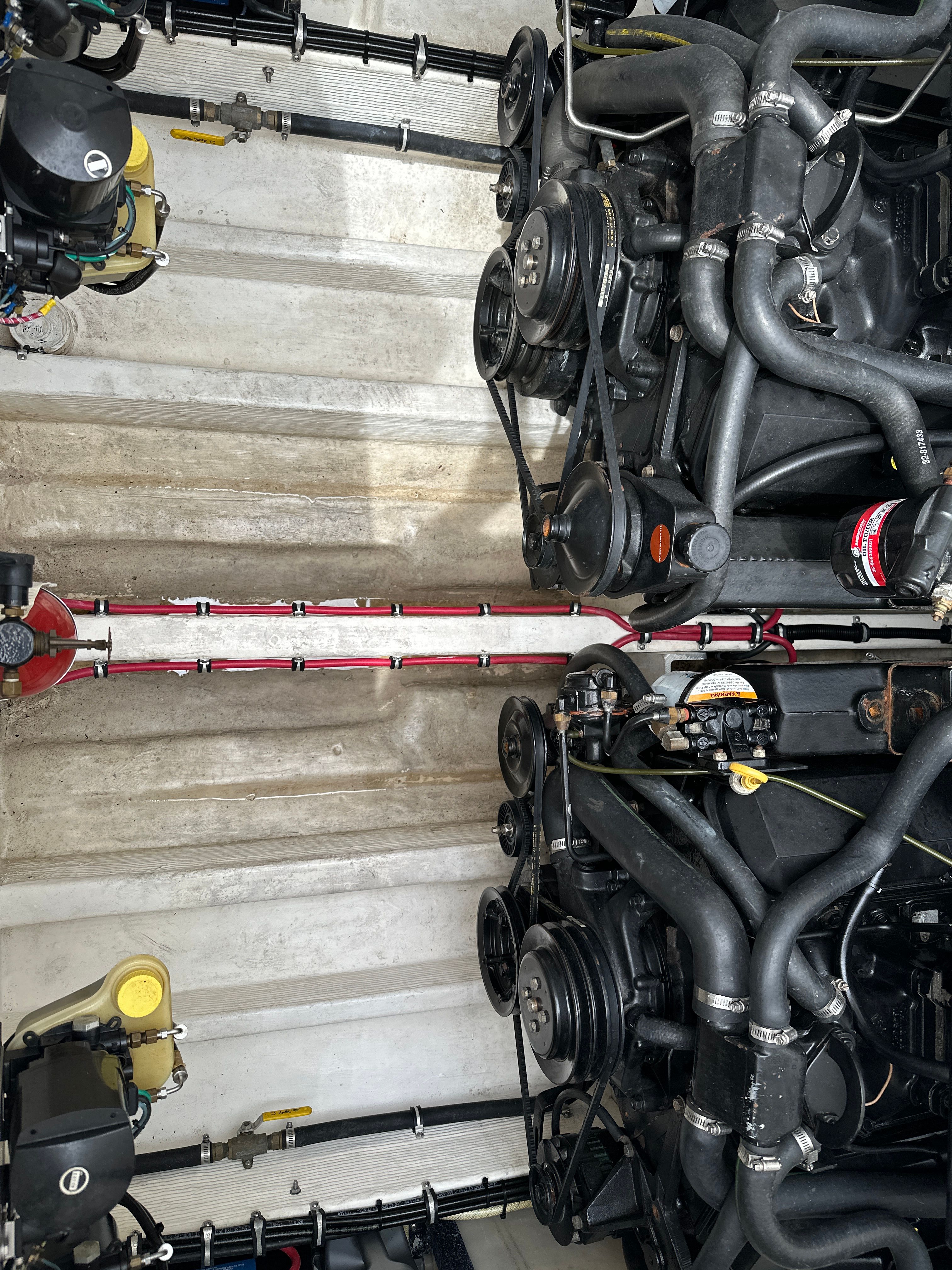 Engine room of a 1994 Fountain EXECUTIONER with two powerful engines and complex piping.
