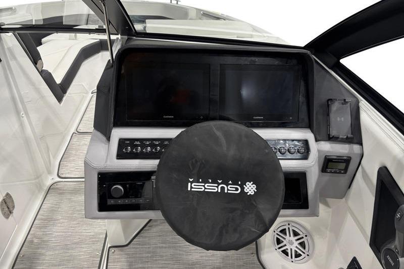 2025 Cobalt R6 boat dashboard with dual screens and Gussi Italia steering wheel cover.