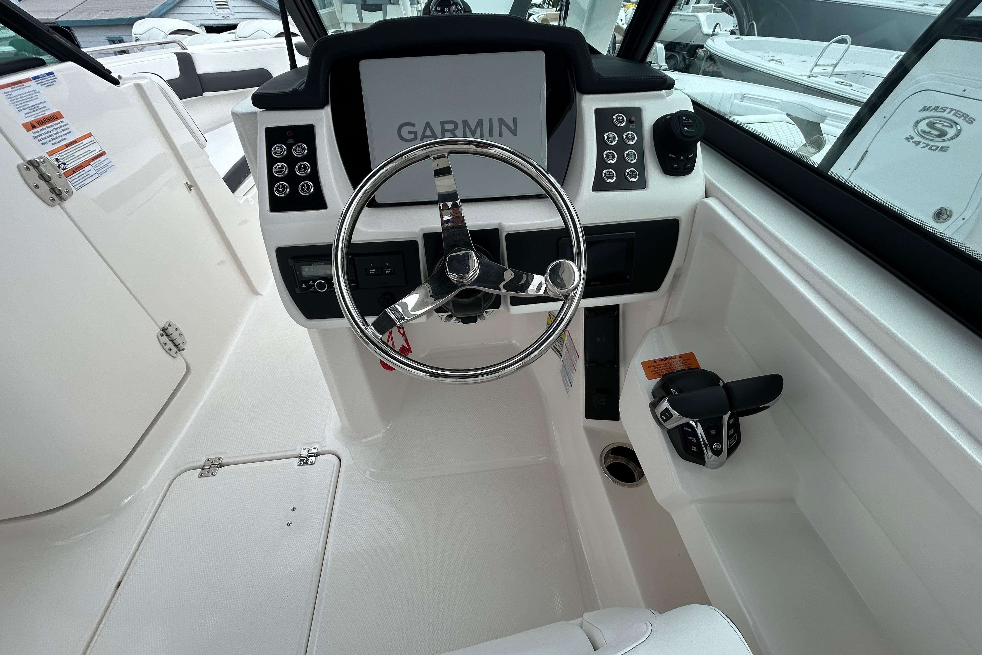 2026 Robalo R257 Dual Console boat cockpit with Garmin navigation system and steering wheel.