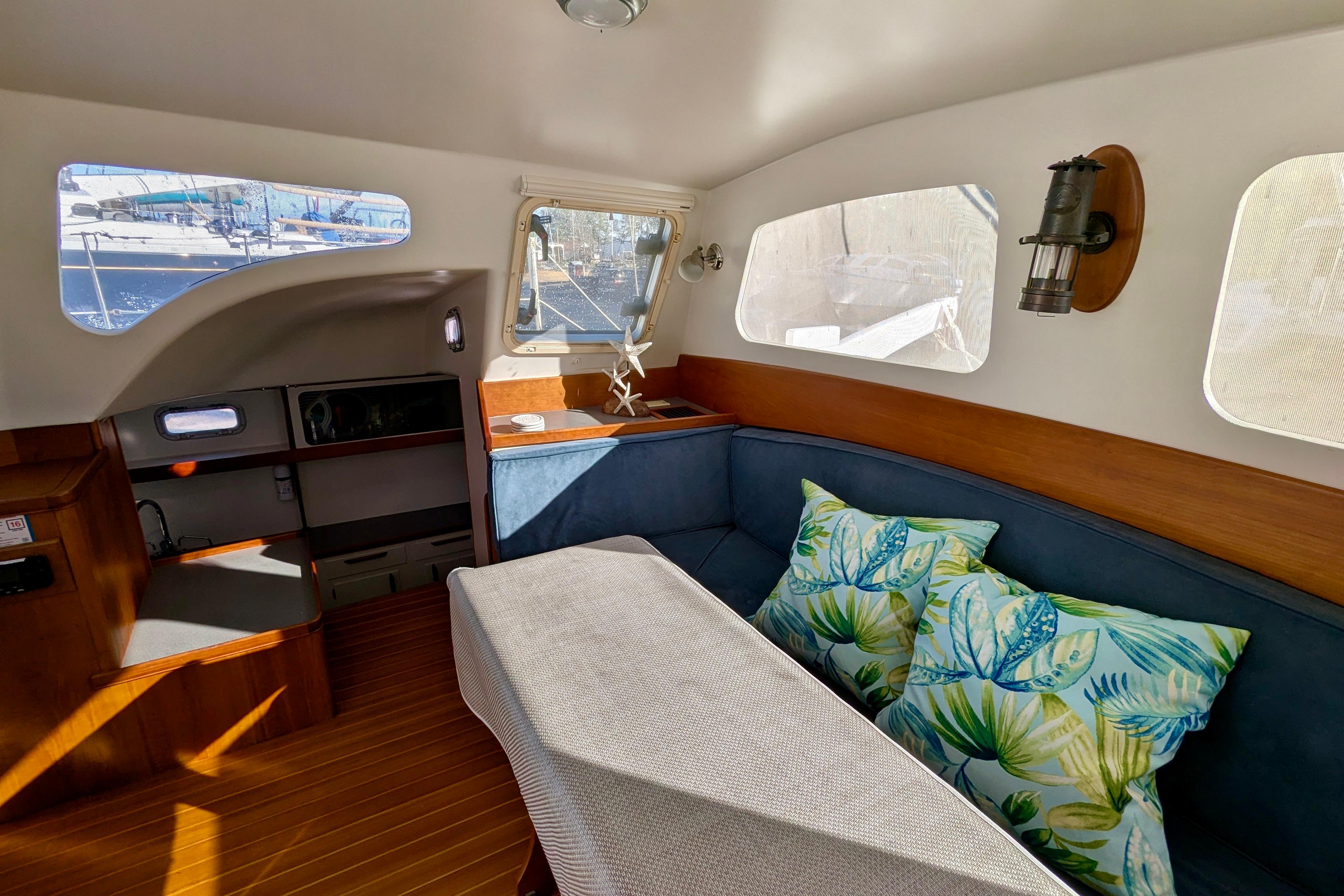 Interior of 2003 Chris White Atlantic 42 yacht with cozy seating and nautical decor.