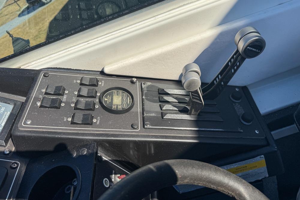 Control panel of a 1989 Formula 292 SR-1 boat with throttle levers and switches.