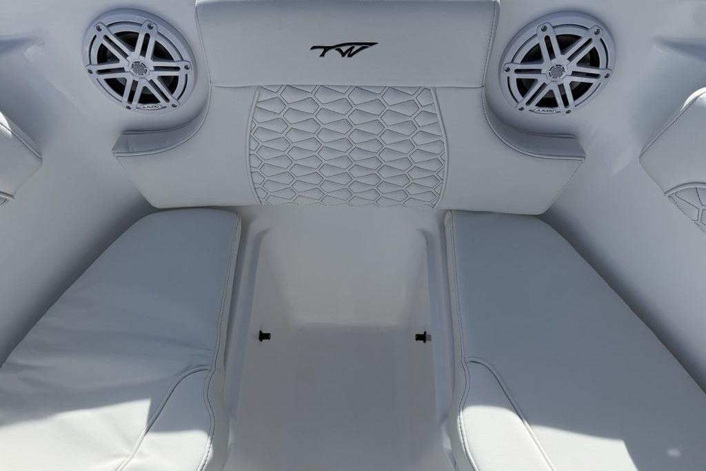 Interior of 2026 Tidewater 232 LXF boat with white seating and speakers.