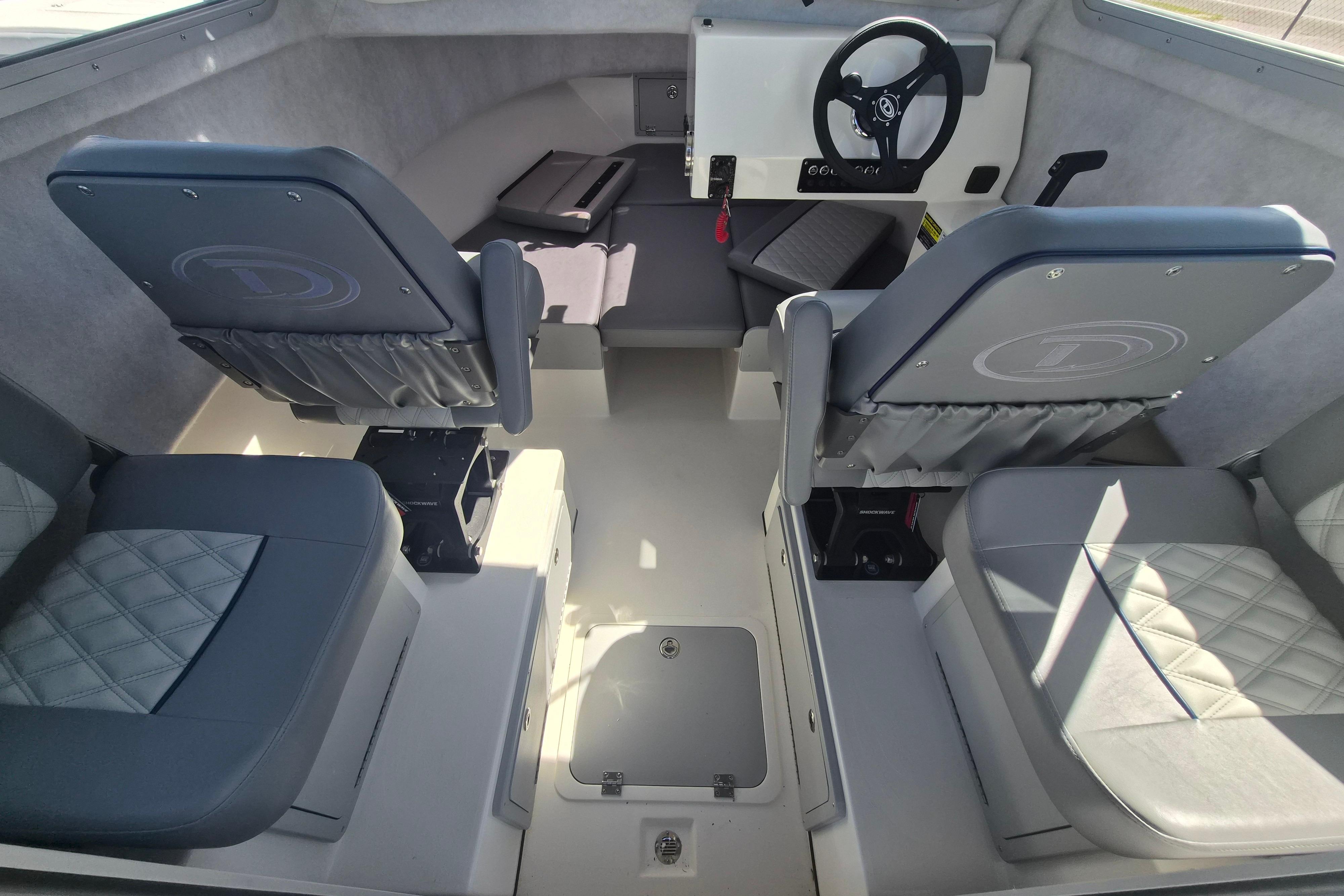 Interior of 2026 Defiance Admiral 220 EX boat with modern seating and steering wheel.