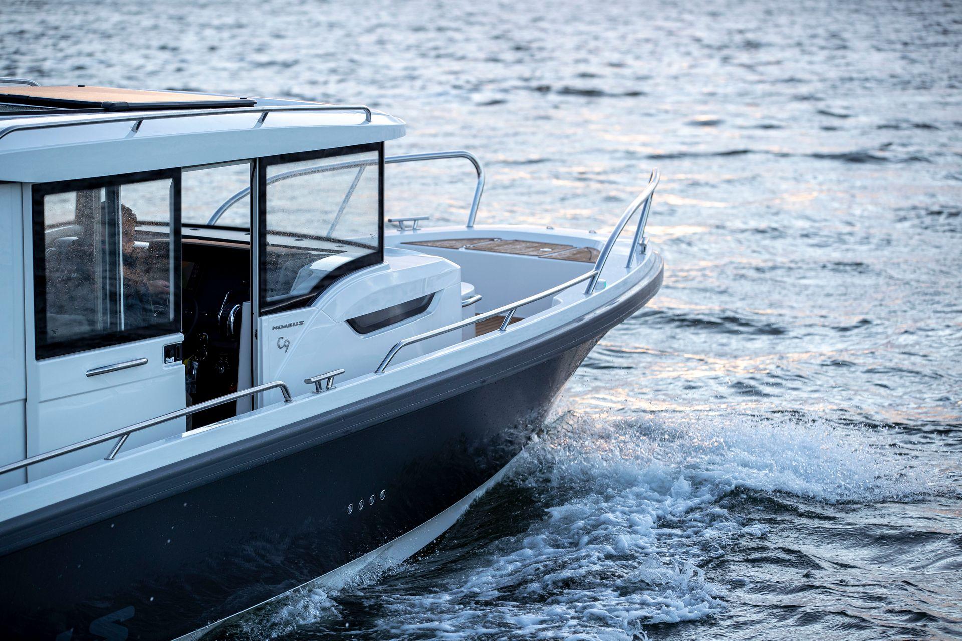 Nimbus C9 2025 boat cruising on open water at sunset.