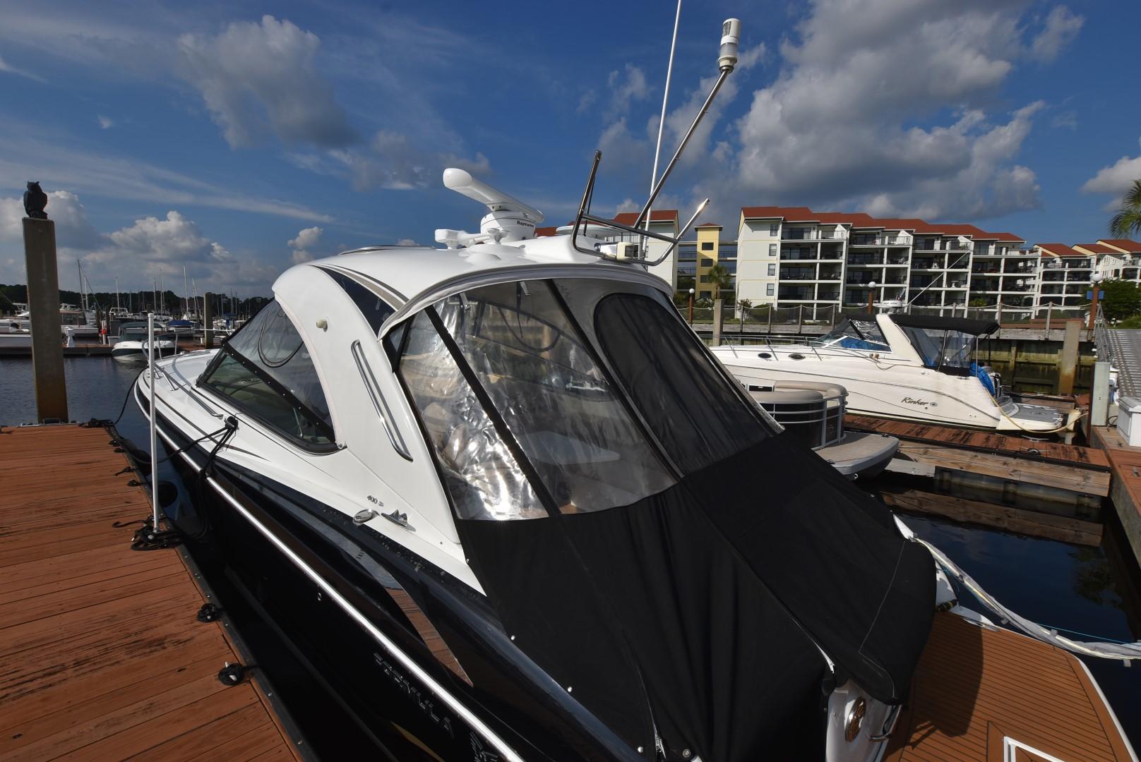 2011 Formula 400ss boat docked at marina with waterfront condos in background.