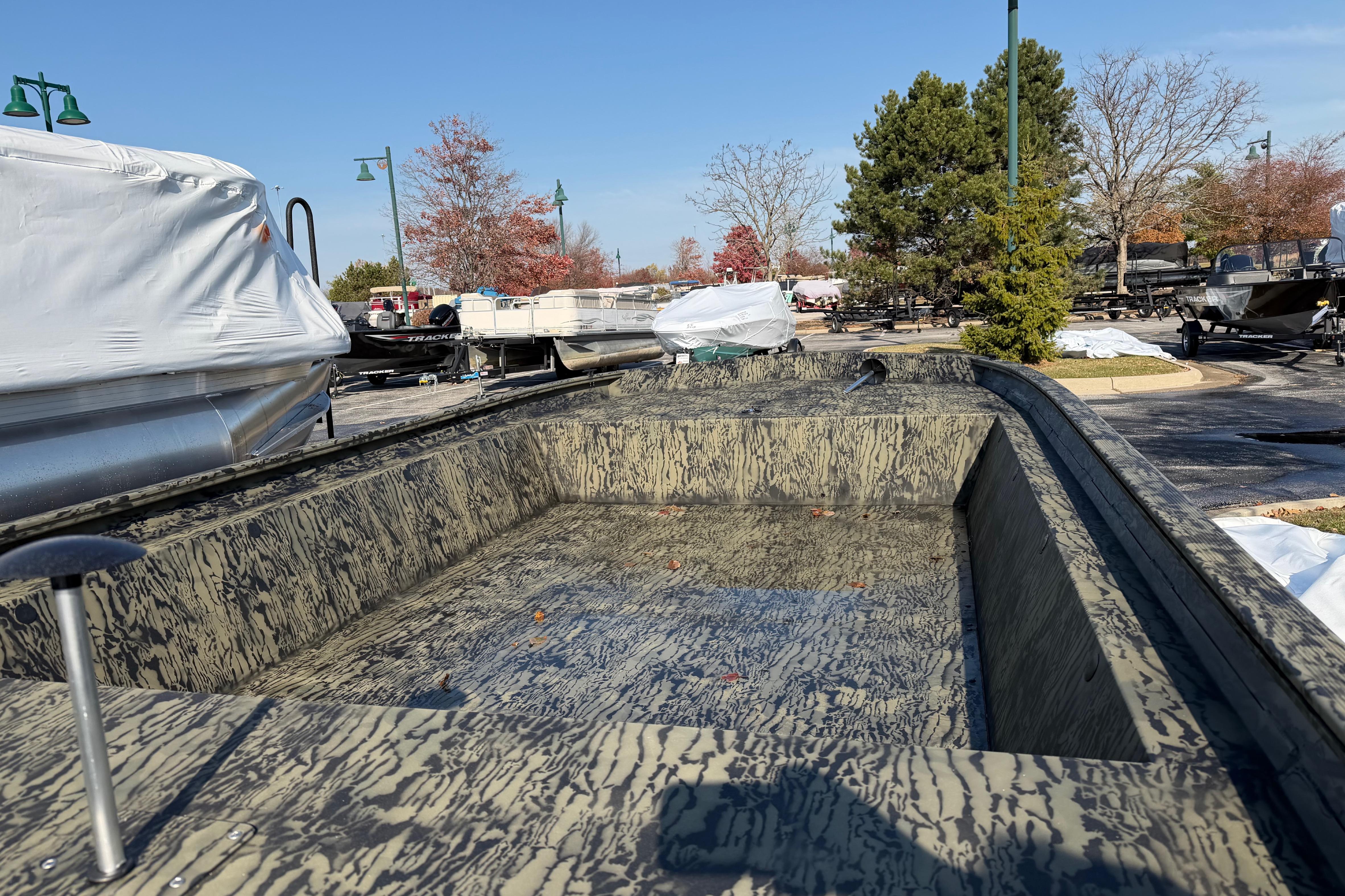 2026 Tracker Grizzly 1860 Utility boat with camouflage design in outdoor setting.