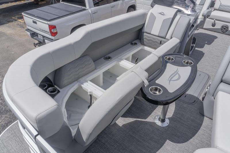 2026 SunCatcher Elite 326 SL boat interior with plush seating and built-in storage compartments.