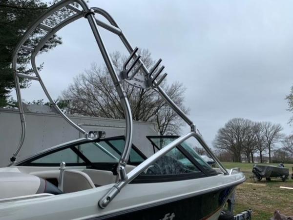 1996 MasterCraft Prostar 205 boat with wakeboard tower in a park setting.