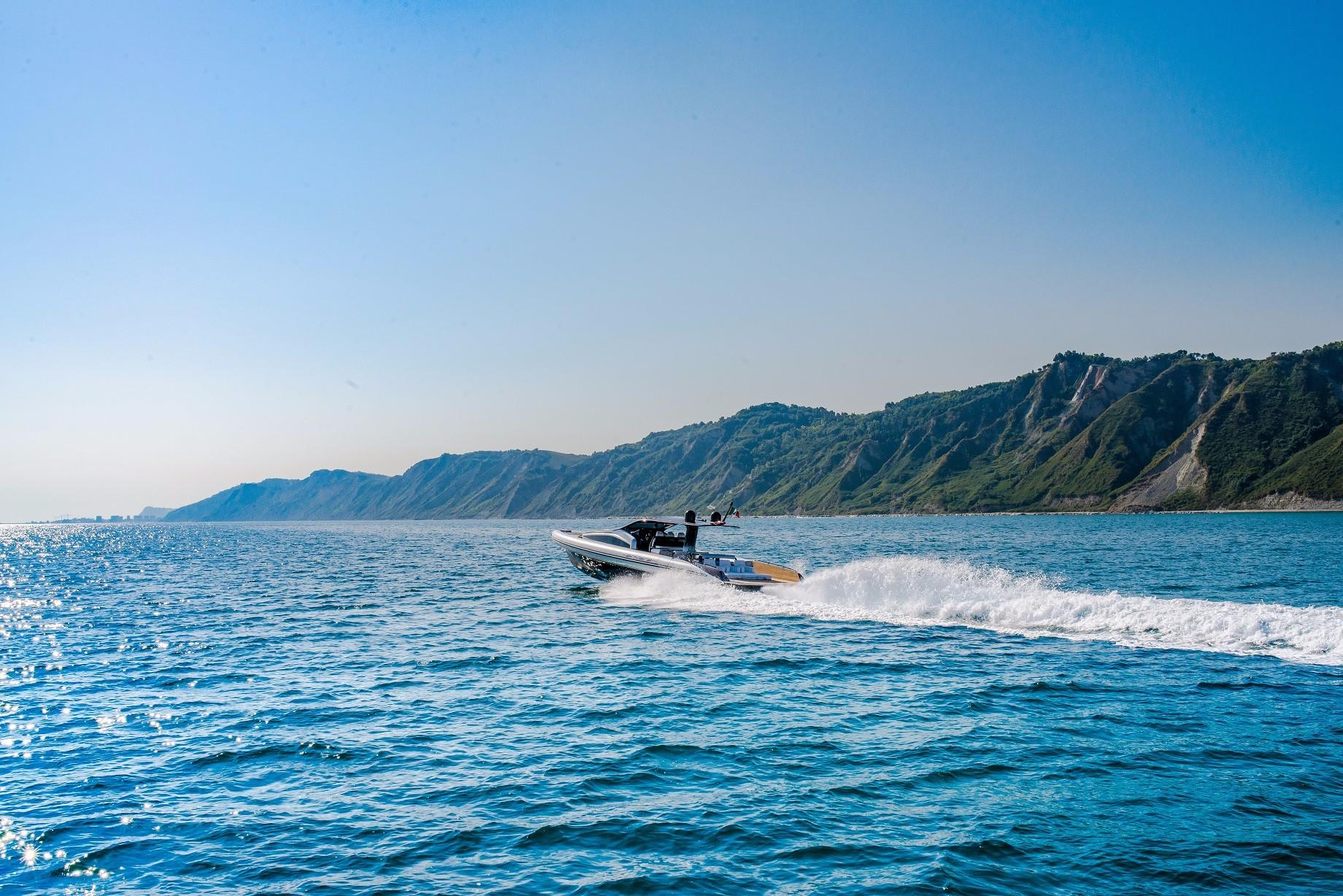 Anvera 58S 2026 speedboat cruising on blue ocean near scenic coastline.