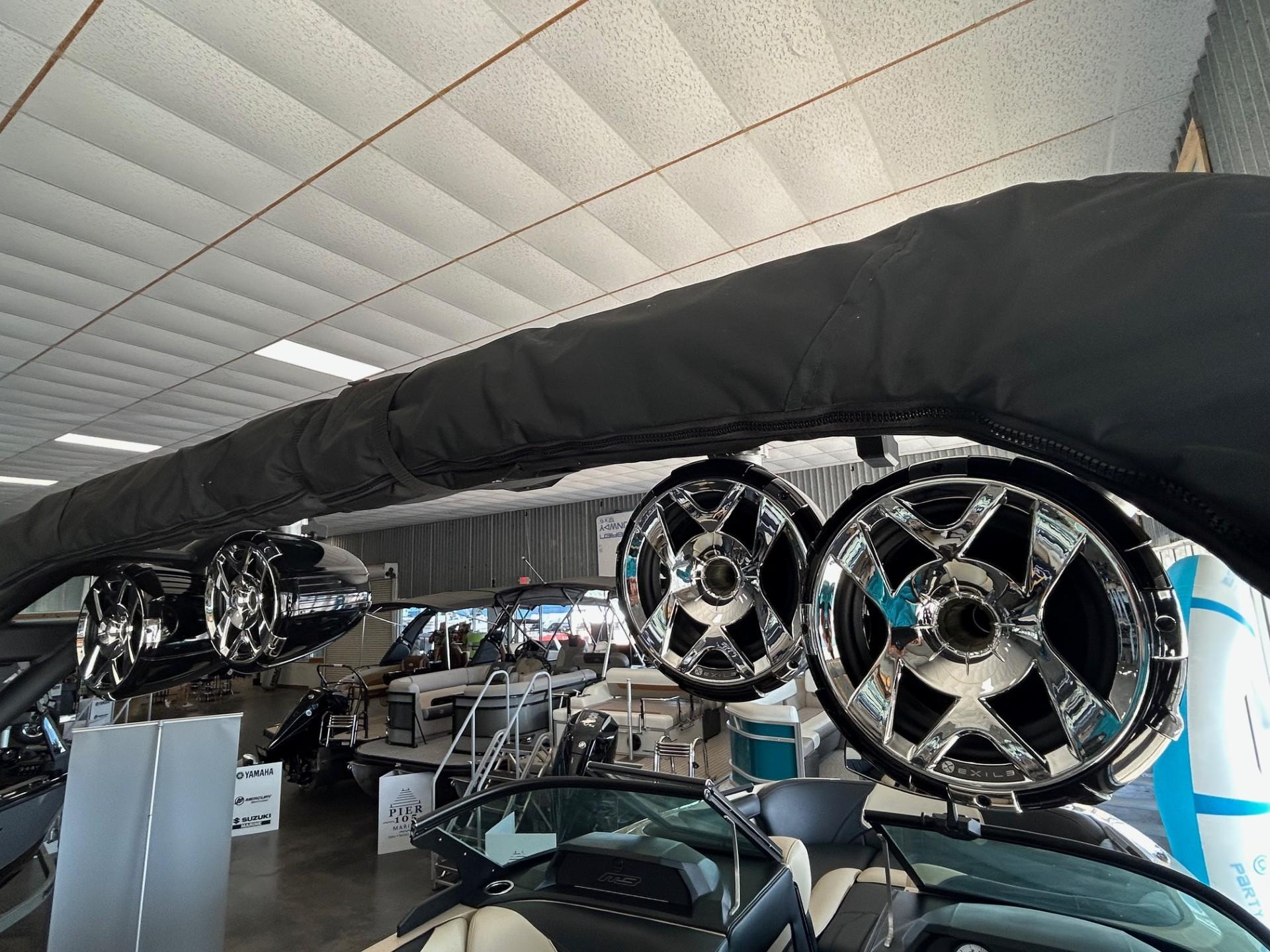 2024 MB F22 Tomcat boat with chrome speakers in a showroom.