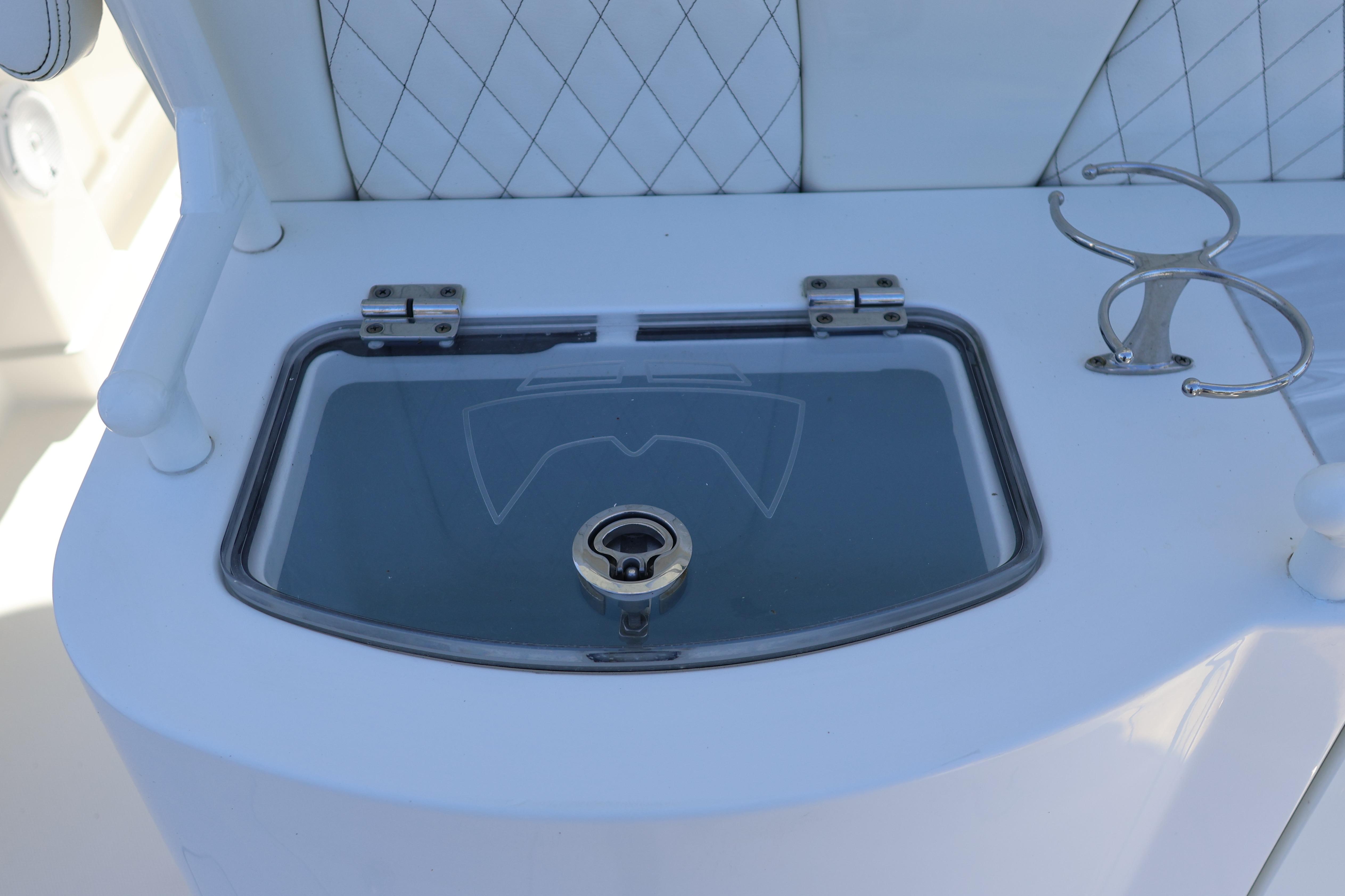 2022 World Cat 280 CC-X boat detail with storage compartment and cup holder.
