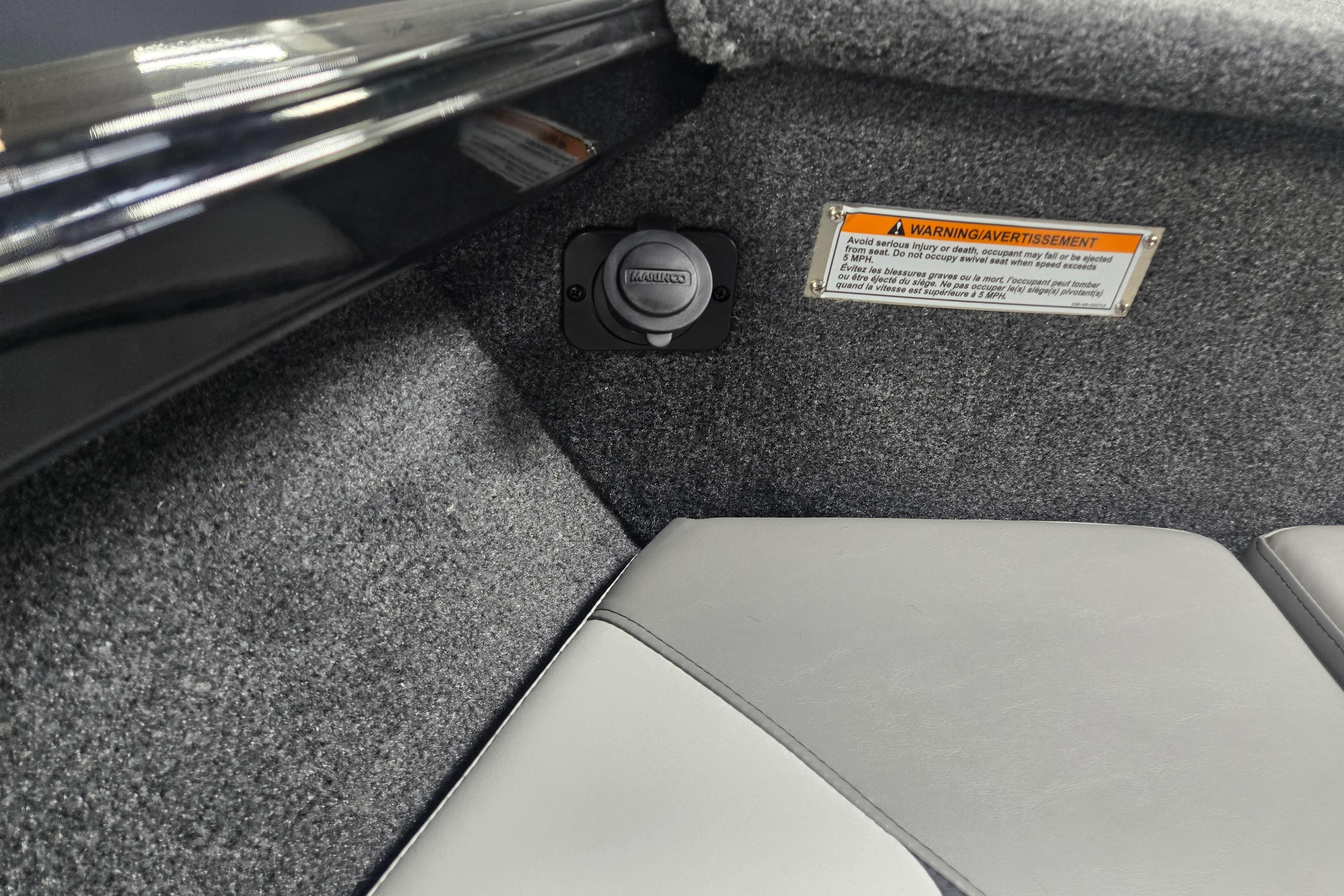 Interior detail of 2026 Princecraft Sport 175 MAX boat with warning label and socket.