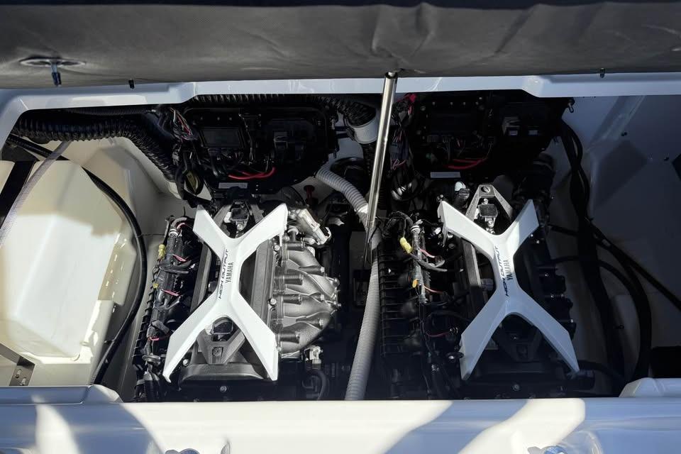 Engine compartment of 2026 Yamaha Boats 252SD, showcasing dual engines and components.