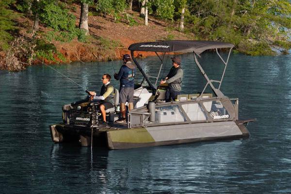 Manufacturer Provided Image: 2026 Sea-Doo Switch Fish 21 pontoon boat with anglers on a serene lake.
