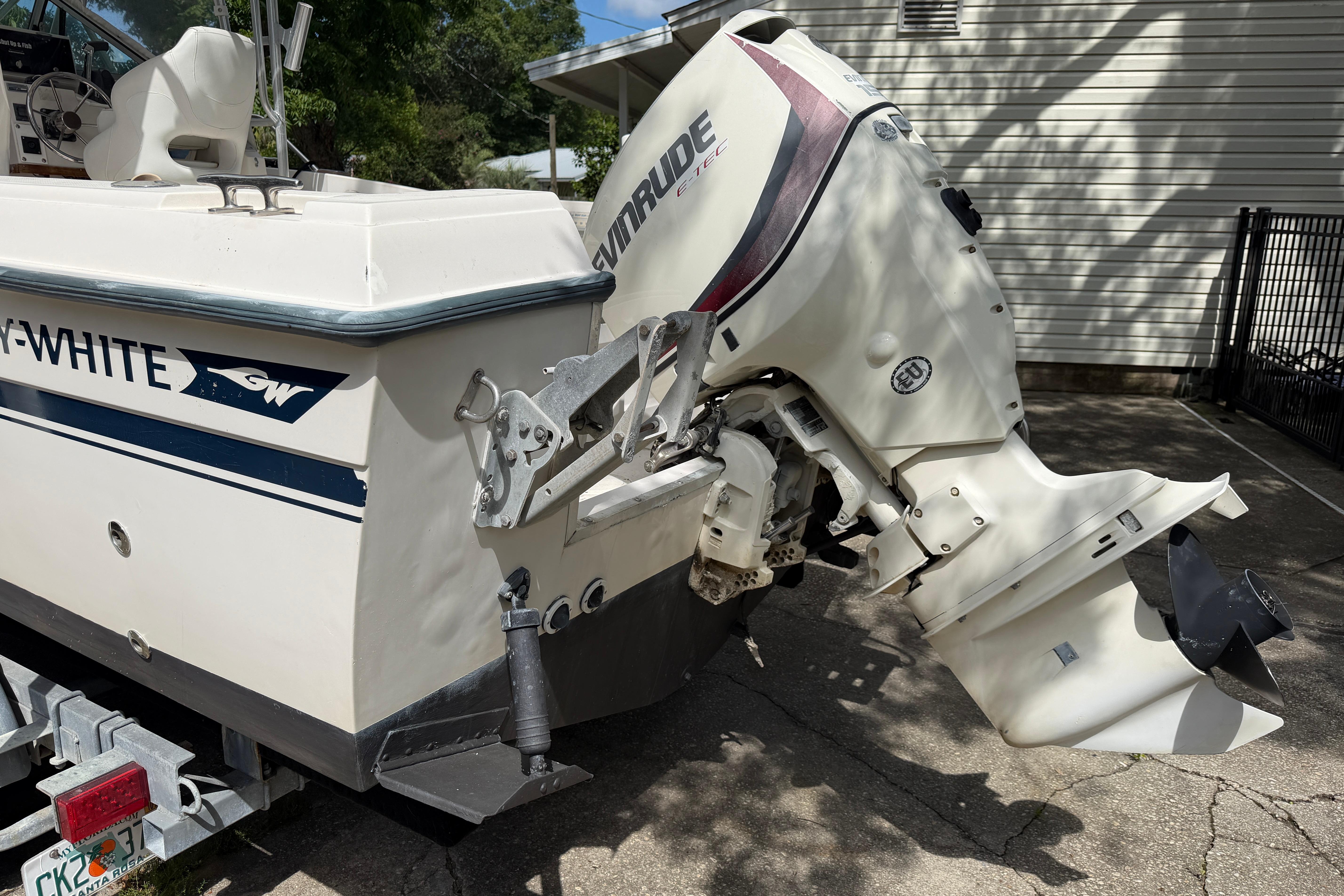 1987 Grady-White Seafarer 226 boat with Evinrude outboard motor, parked on a driveway.