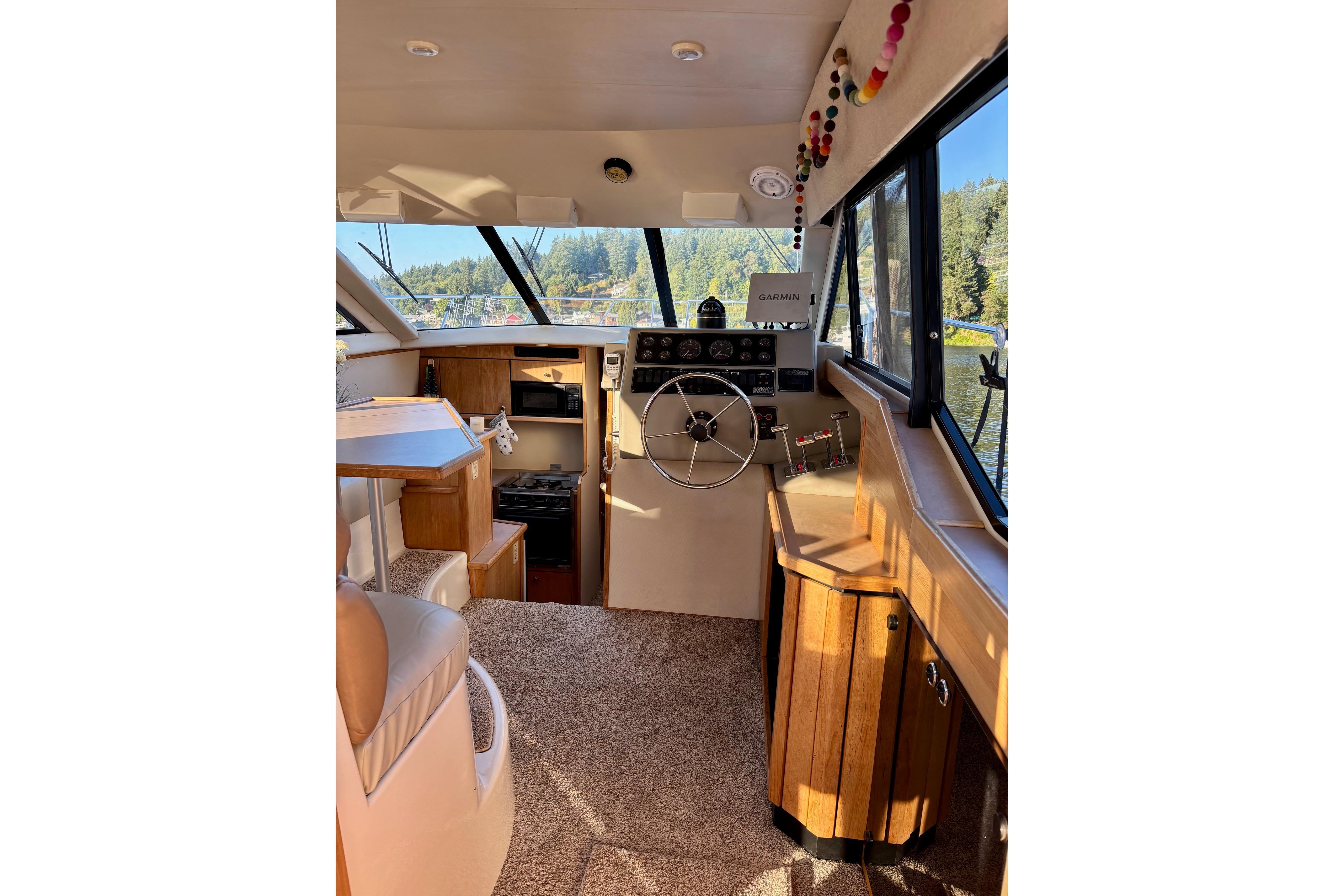 1998 Bayliner 3388 Command Bridge Motoryacht interior with helm, seating, and navigation equipment.
