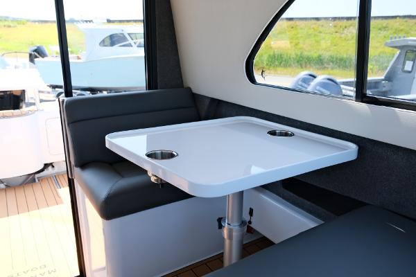 Interior of 2023 Makaira Gen3 800 boat with seating and table.