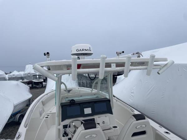 2023 Sailfish 290 CC boat with Garmin radar, docked and covered.