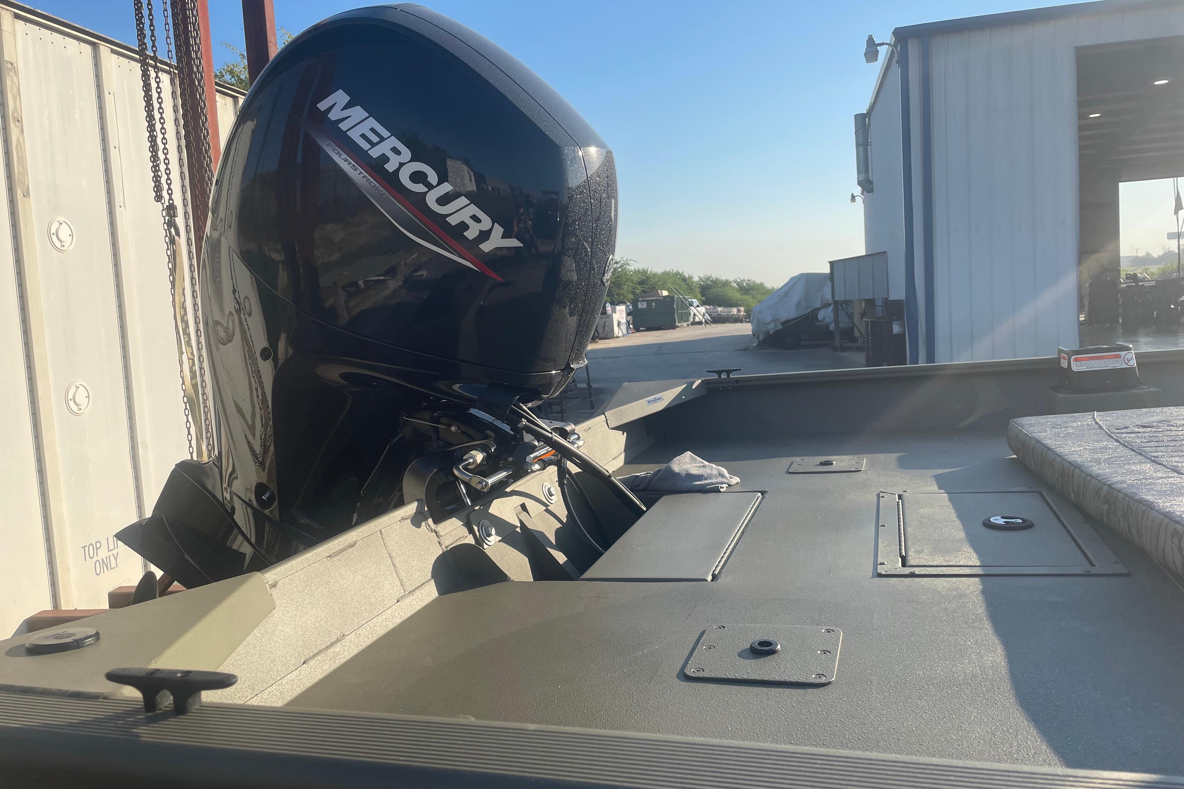 2026 Tracker Grizzly 2072 CC boat with Mercury outboard motor in a sunny outdoor setting.
