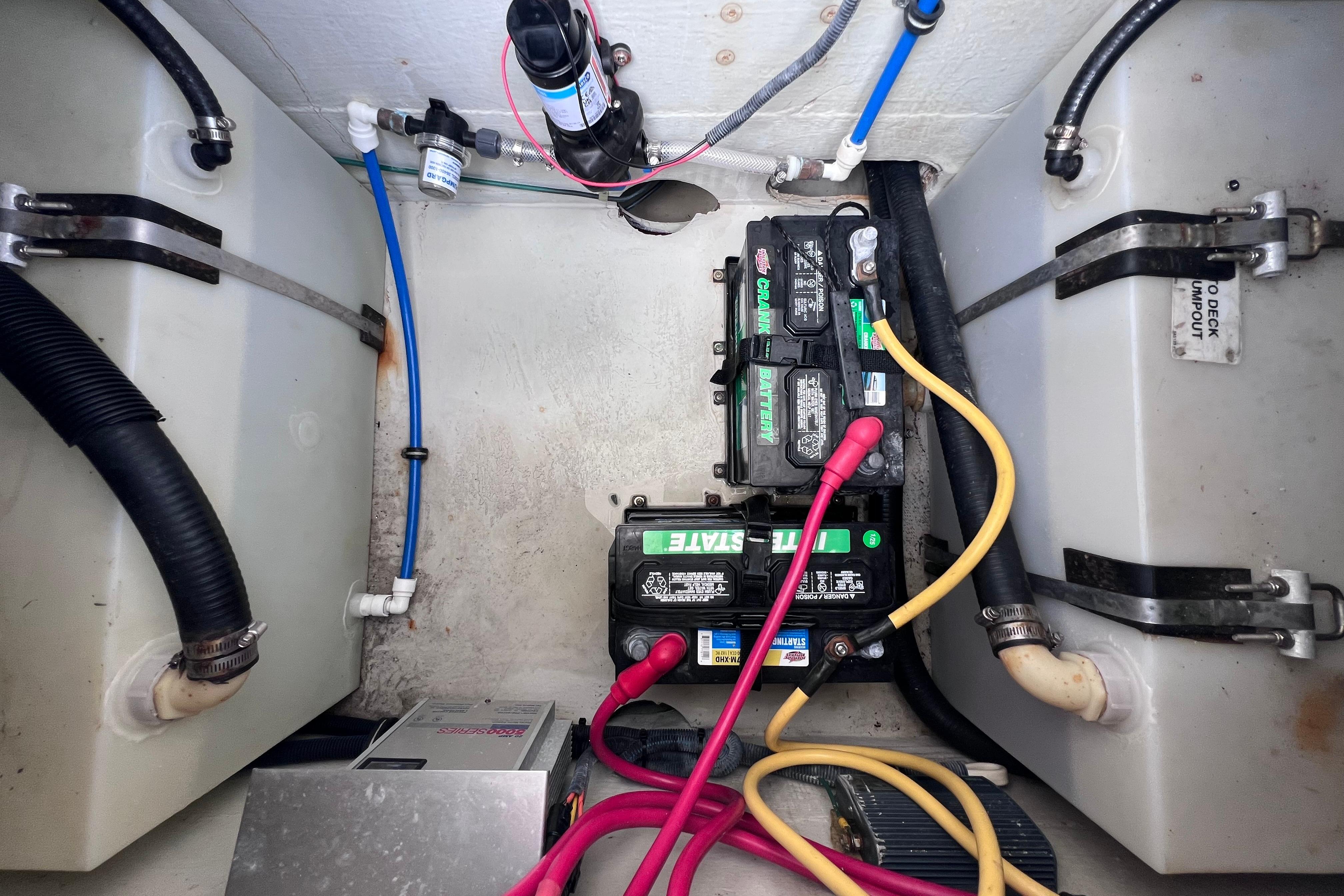 2004 Pursuit 2870 Walkaround boat battery compartment with wiring and tanks.