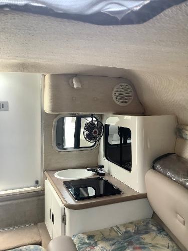 Interior of 1998 Chaparral 2335 SS boat with kitchenette and seating area.