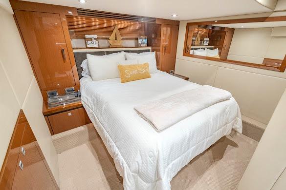 Luxurious bedroom interior of 2016 Sea Ray Sundancer 510 yacht with elegant bedding.