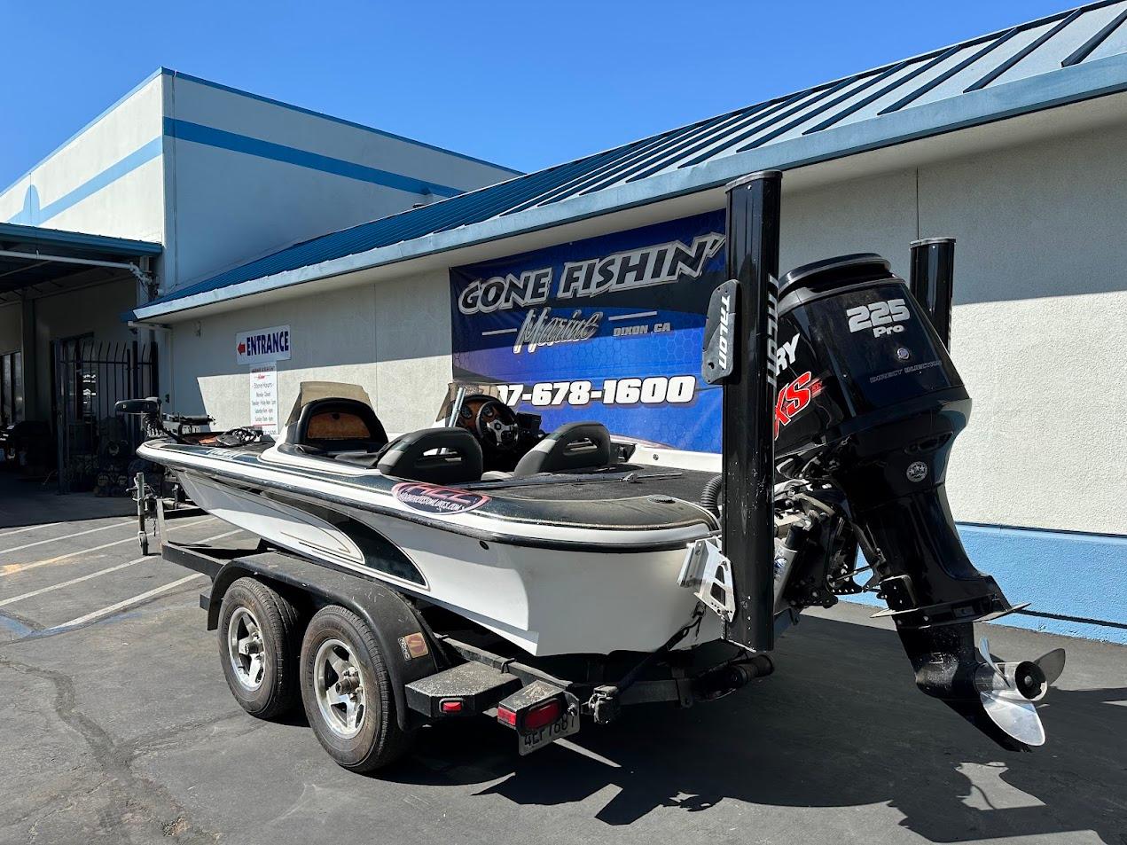 1999 Fisher 21 FX DC boat with Mercury 225 Pro XS engine on trailer.