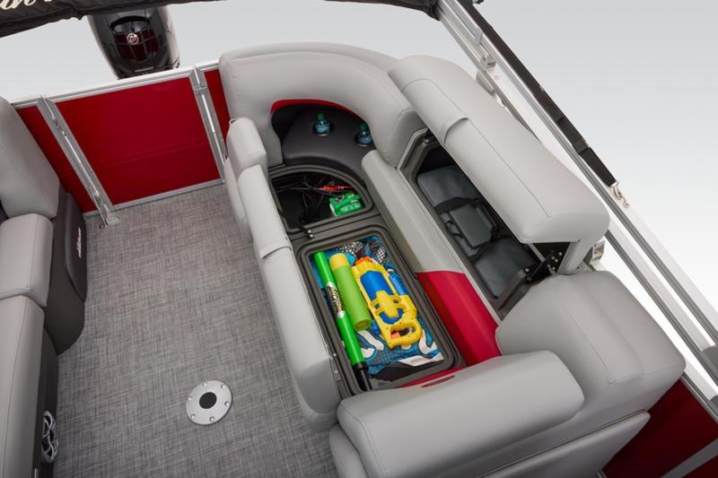 2026 Sun Tracker Party Barge 22 DLX interior with storage compartment open, revealing water toys.