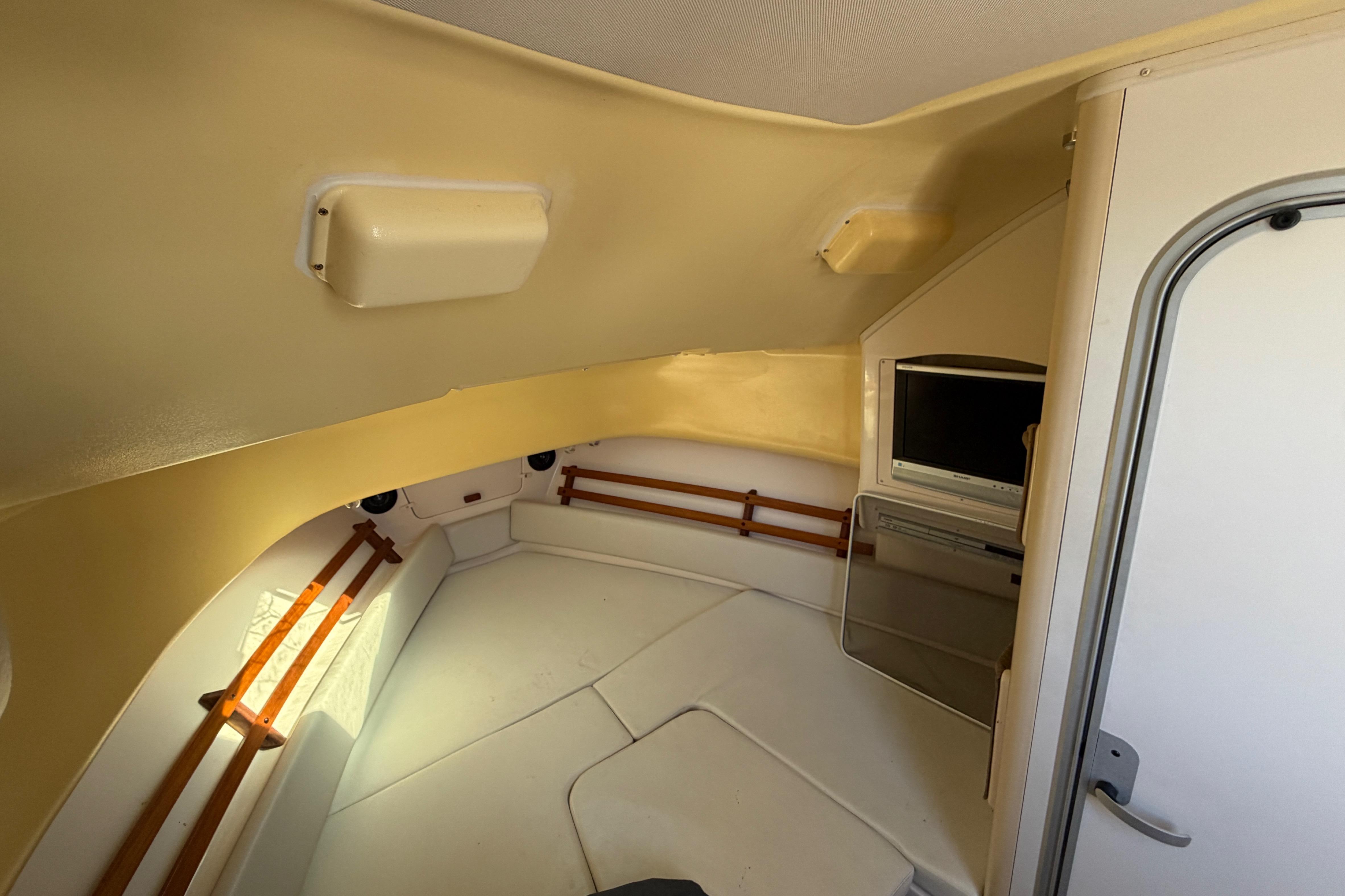 Interior cabin of 2006 Grady-White Sailfish 282 boat with TV and seating area.