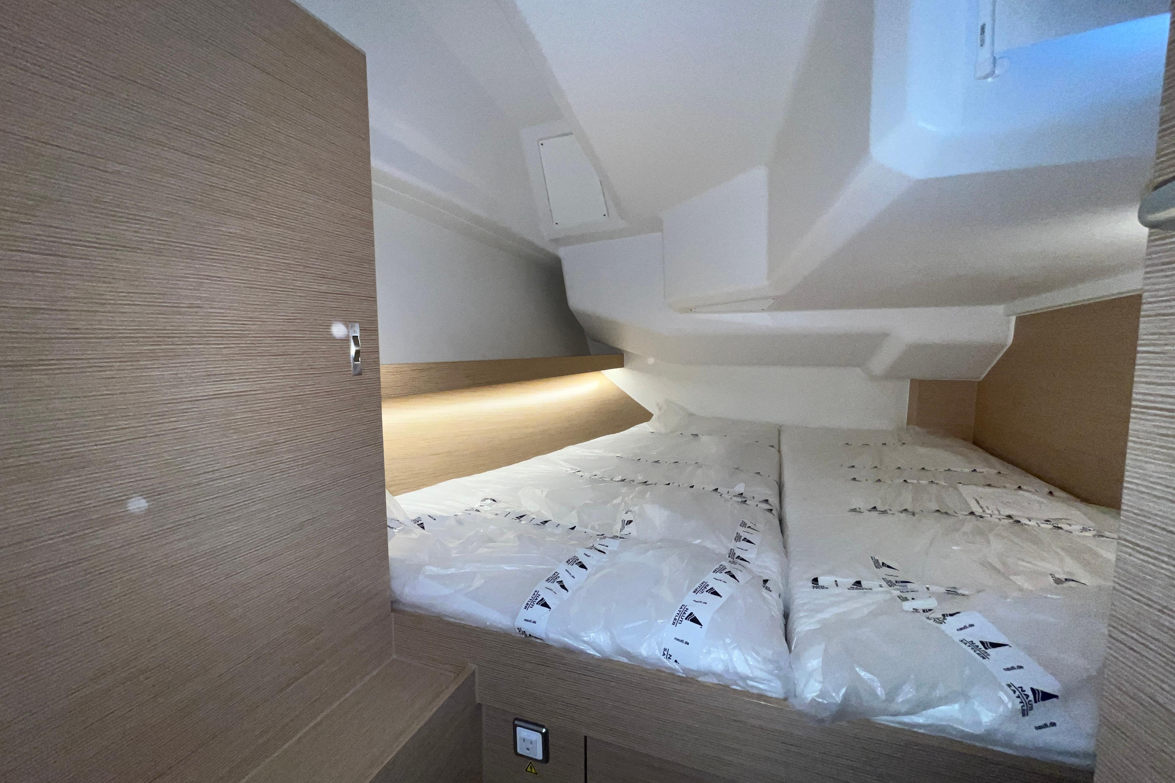 Interior cabin of 2025 Hanse 360 yacht, featuring a cozy double bed setup.