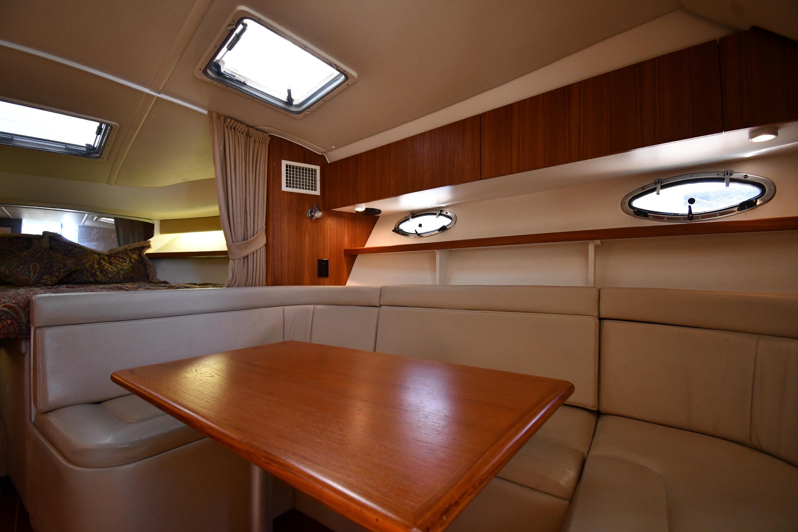 1998 Tiara Yachts 3100 Open cabin interior with seating and table.