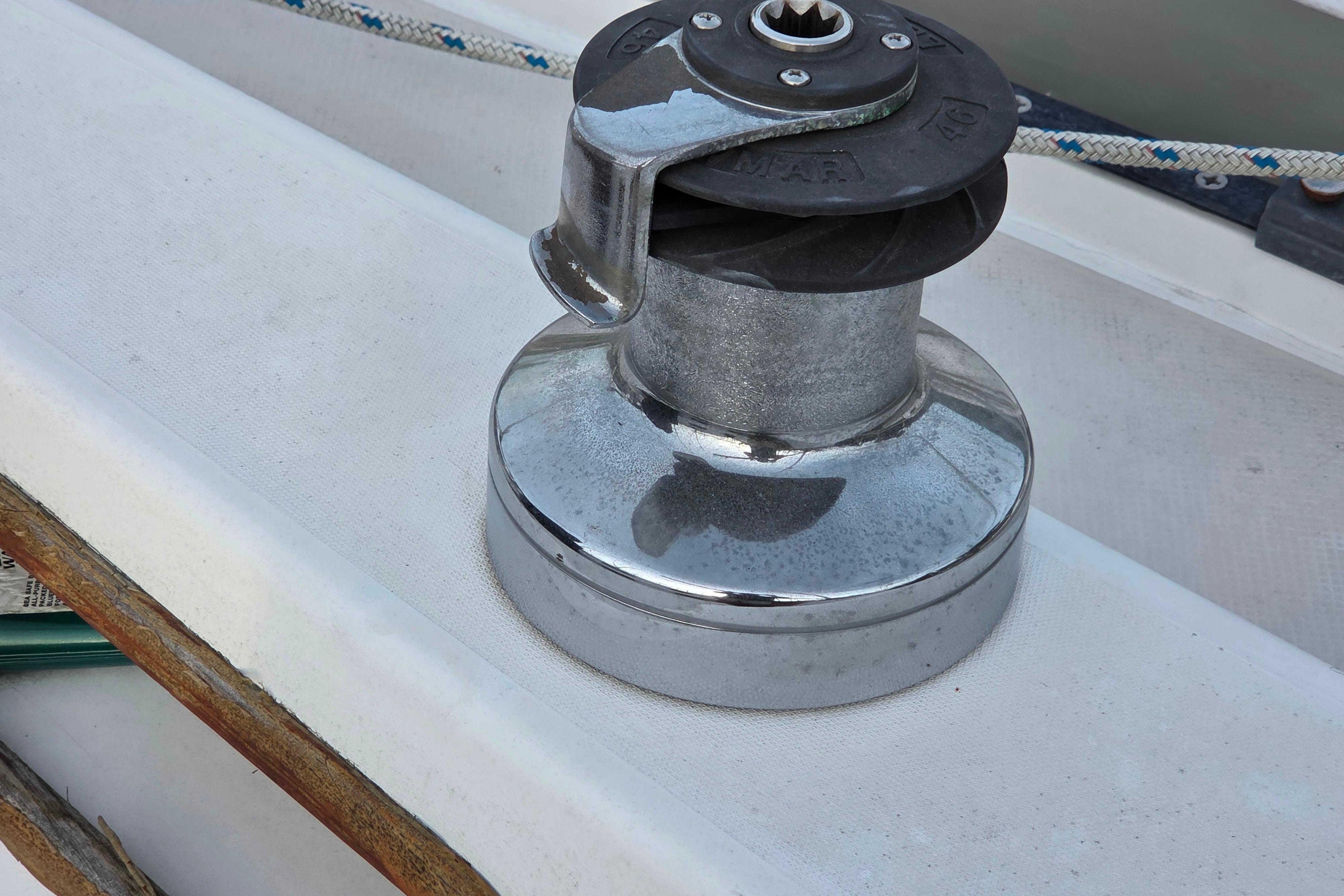 Winch on 1986 Catalina 355 sailboat deck, with rope and metal components.