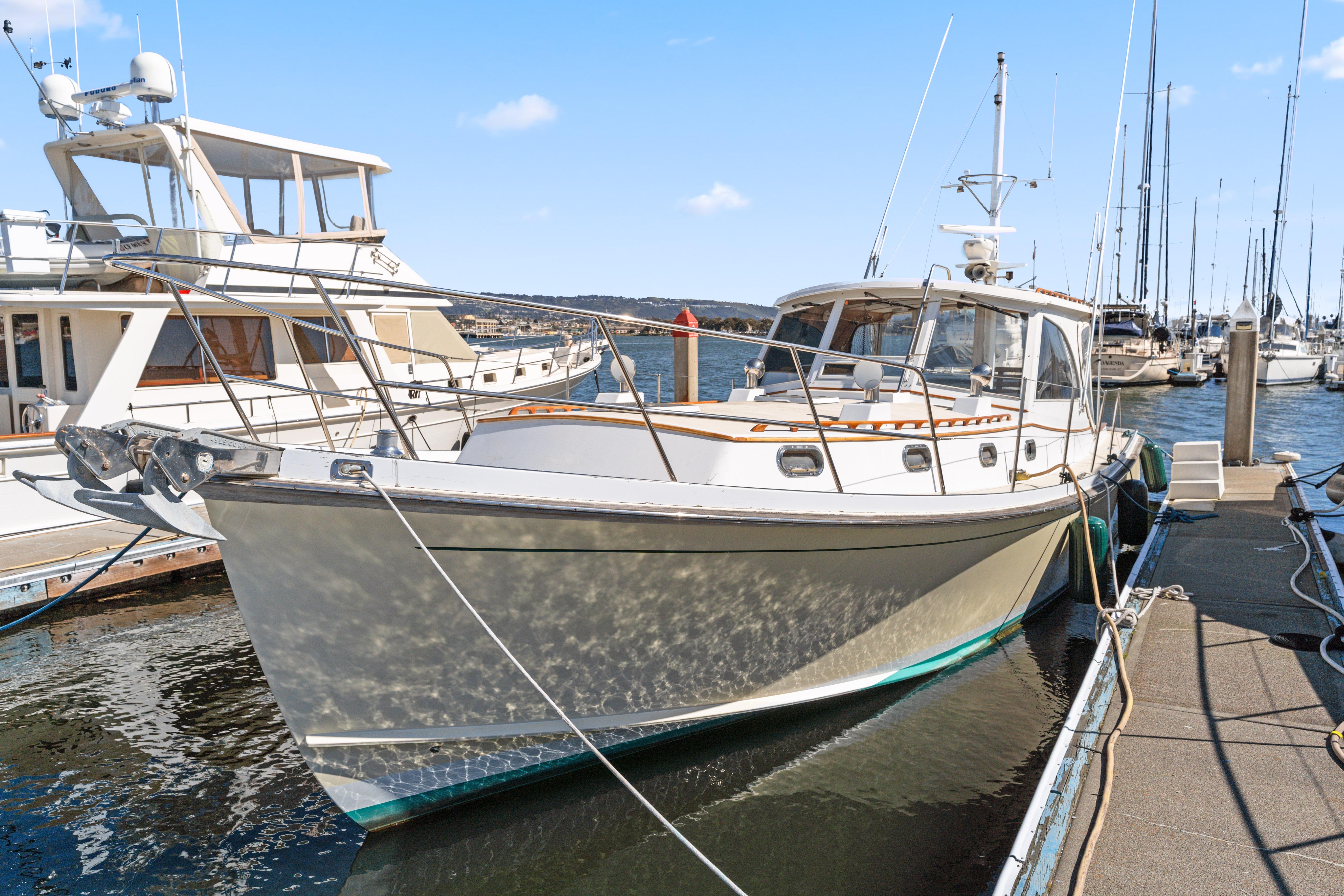 1999 Able 44 boat docked at marina under clear blue sky.