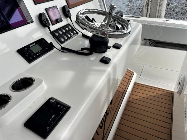 2020 Front Runner 39 Center Console helm with modern controls and teak flooring.