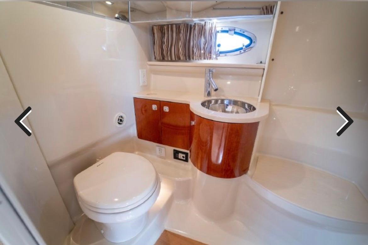 Luxurious bathroom in 2011 Formula 400 Super Sport yacht with modern fixtures and wood accents.