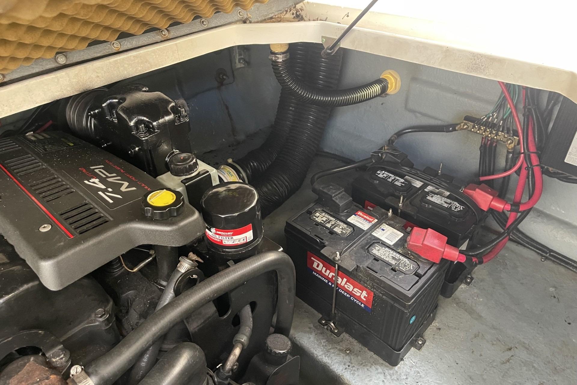 Engine compartment of a 2000 Sea Ray Sundancer 260 with batteries and wiring.