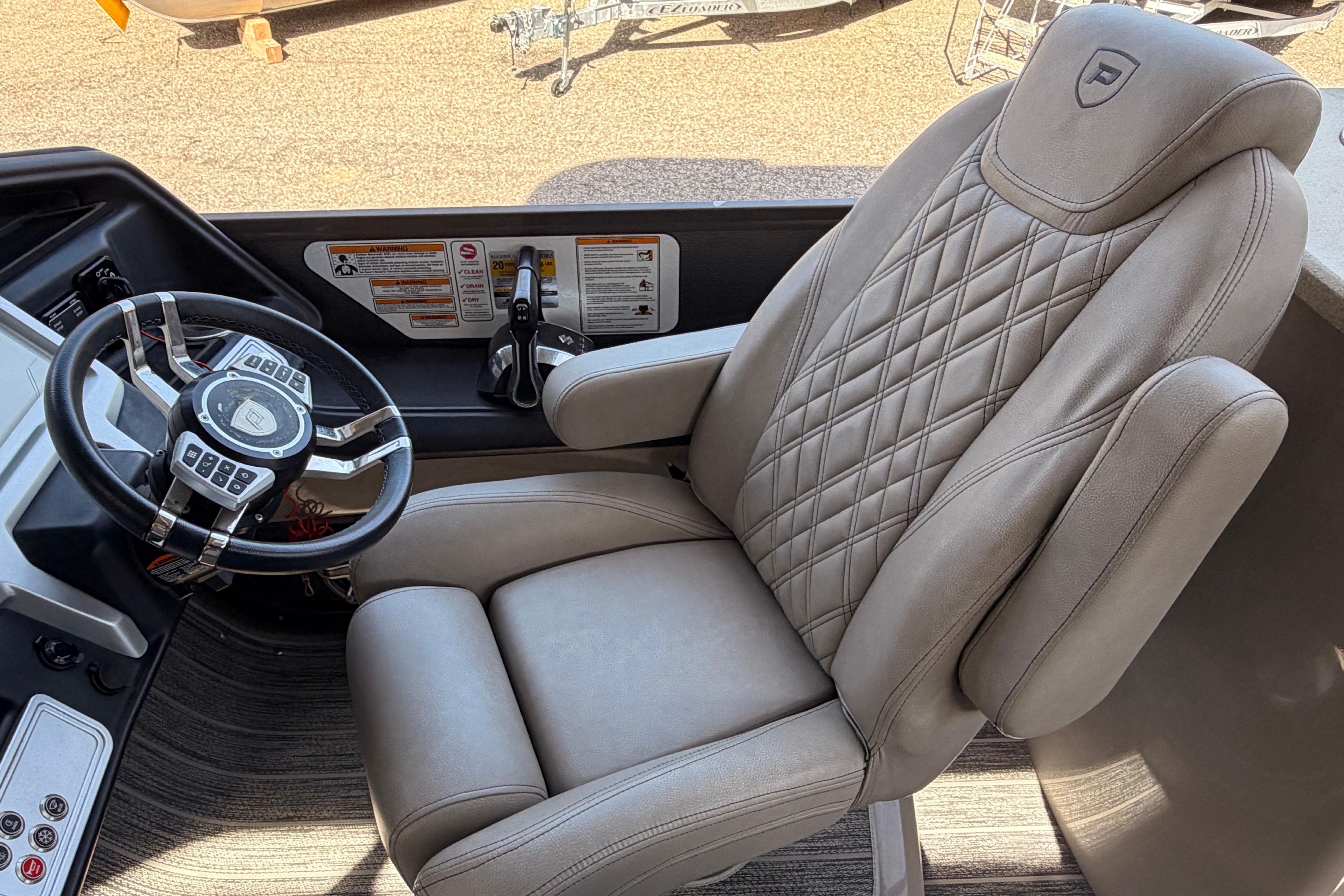 Luxurious driver's seat and steering wheel of 2022 Premier 350 Escalante boat.