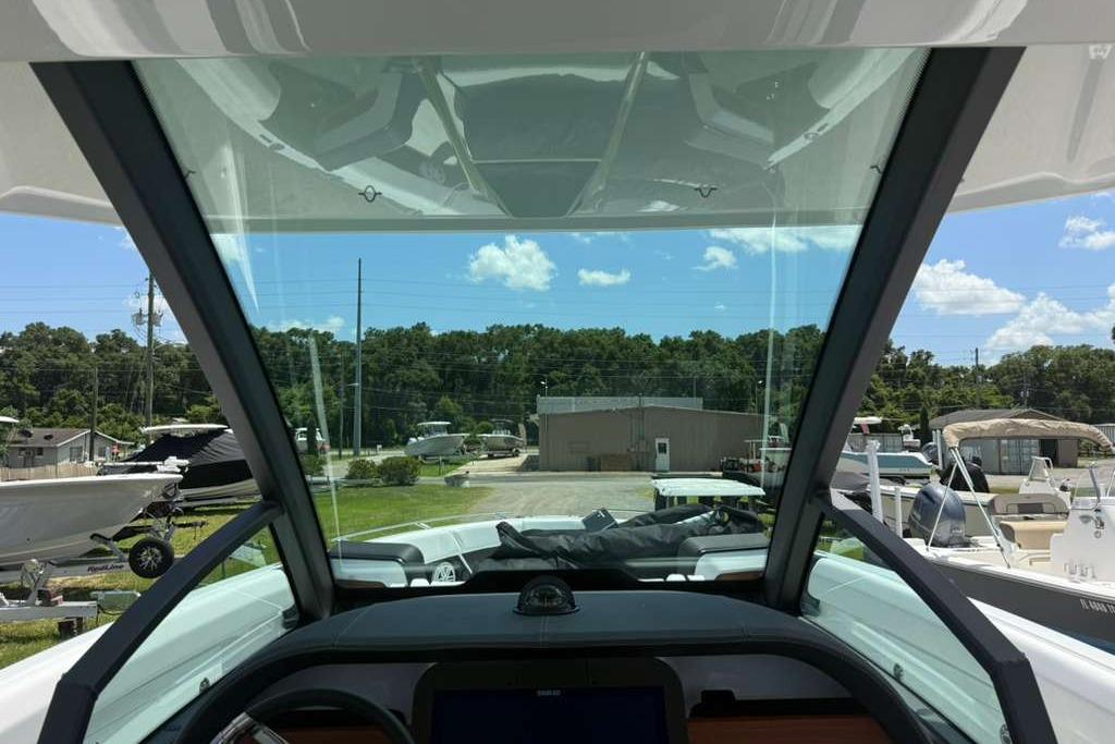 Interior view of 2026 Monterey Elite 30 OB boat, showcasing windshield and dashboard.