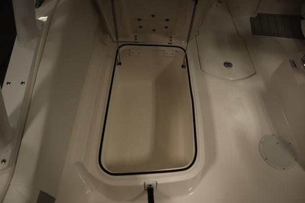 2025 Sea Fox 228 Traveler boat storage compartment, open and empty.