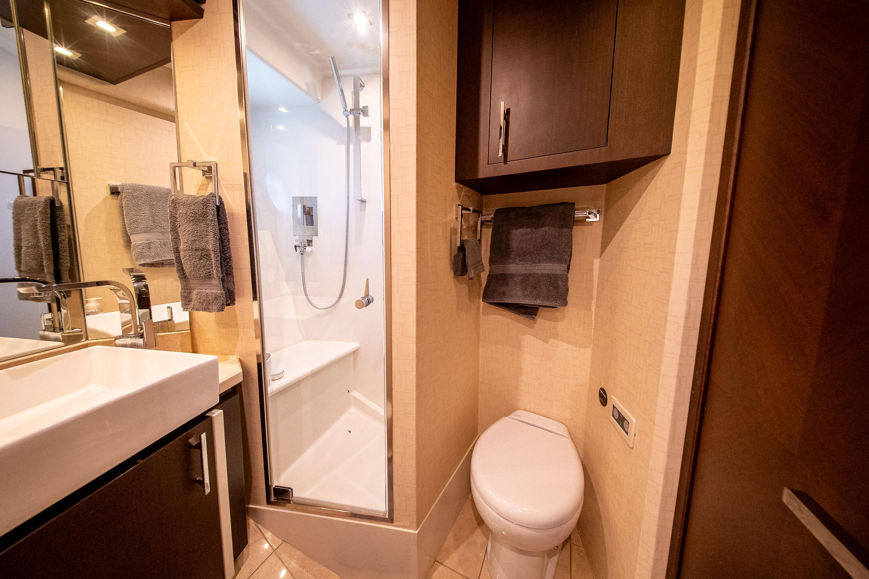 Luxurious bathroom in 2012 Marquis 690 yacht with modern fixtures and elegant design.