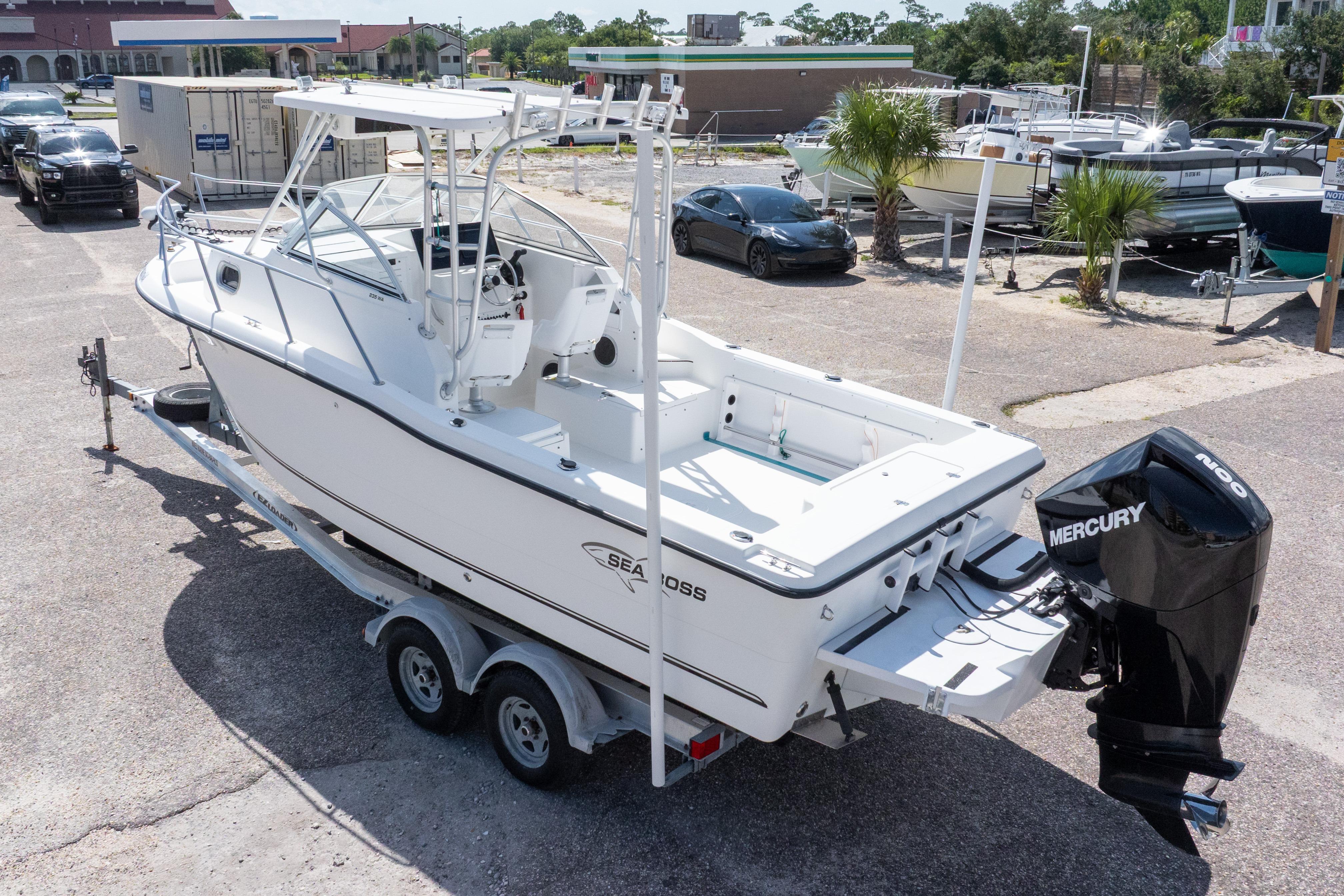 2007 Sea Boss 235 Walkaround boat with Mercury outboard engine on trailer.