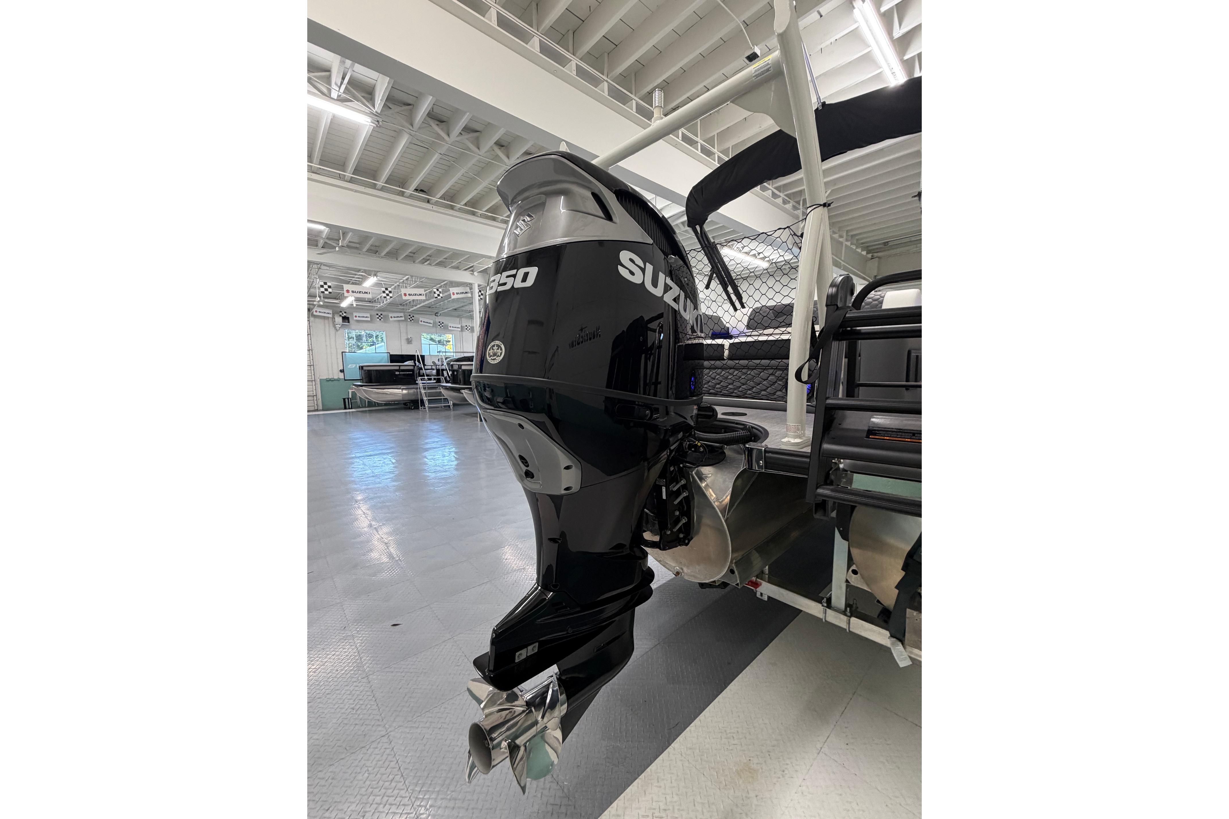 2026 South Bay 525SB2 boat with Suzuki 350 outboard motor in showroom.