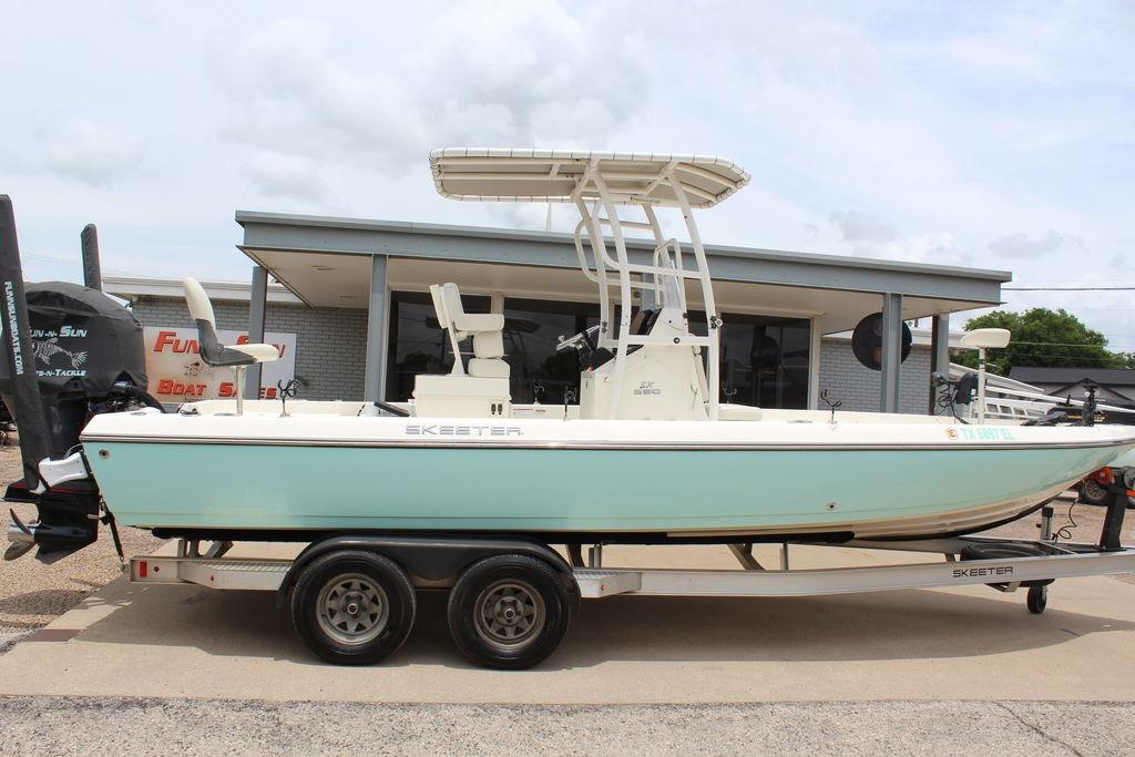 2026 Skeeter SX230 boat on trailer outside dealership.