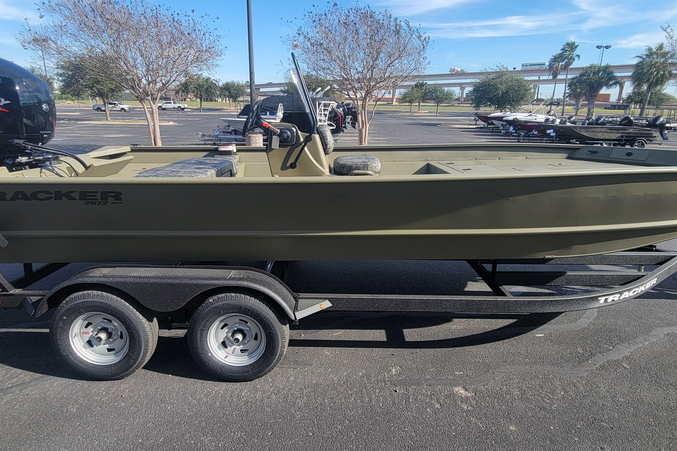 2026 Tracker Grizzly 2072 CC boat on trailer in parking lot.