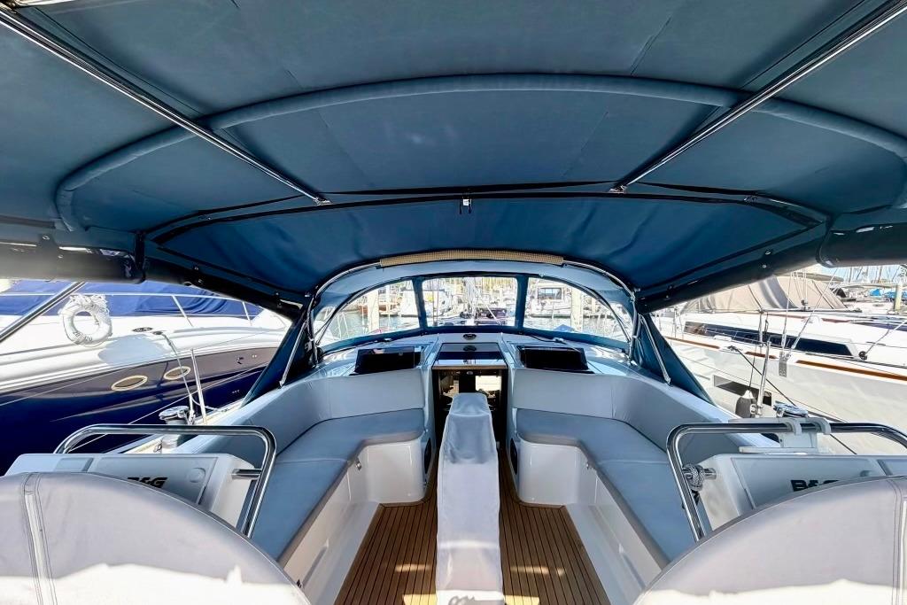 Interior view of 2016 Hanse 455 yacht cockpit with blue canopy and seating.
