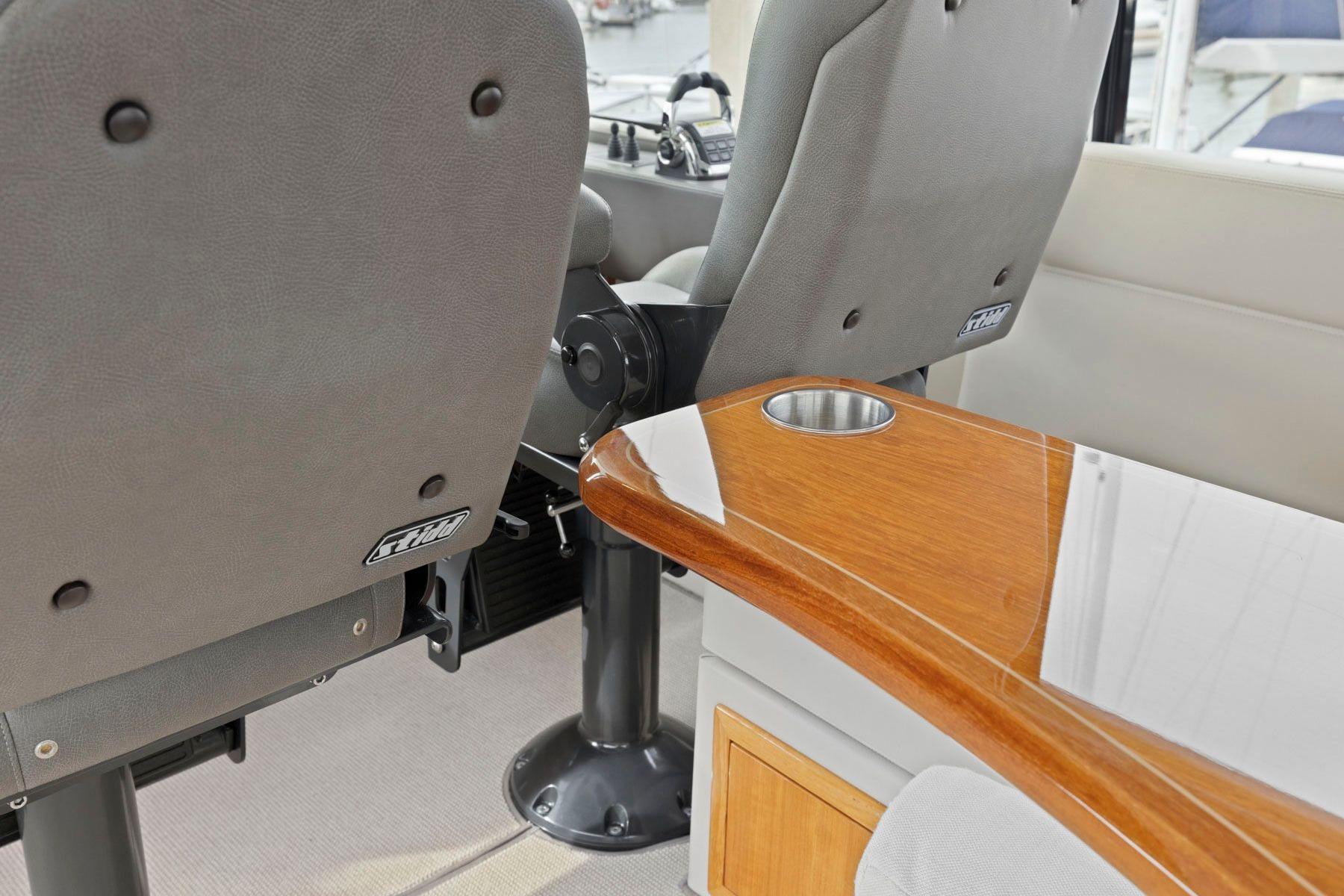 Interior of 2014 Maritimo M50 yacht with plush seating and wooden table.